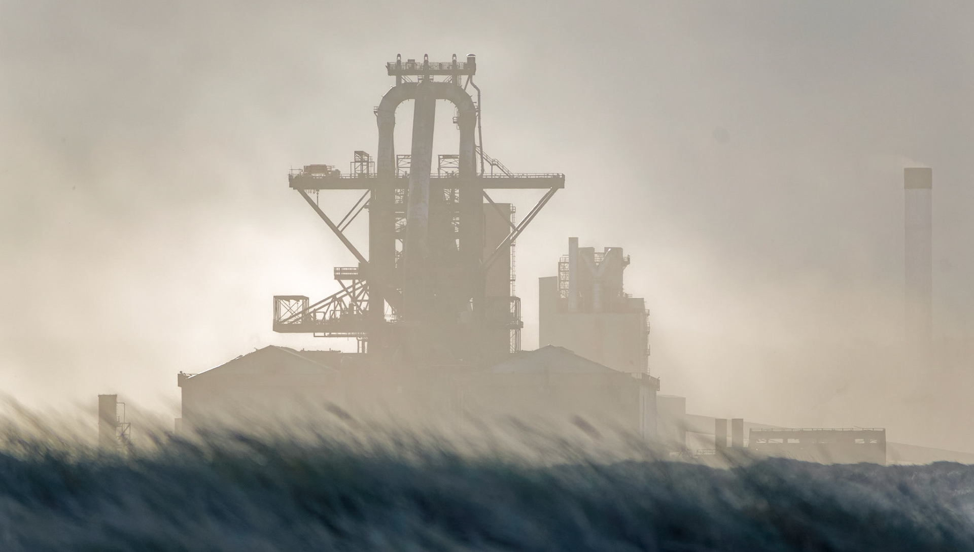 Redcar steel works in a sandstorm across the dunes.