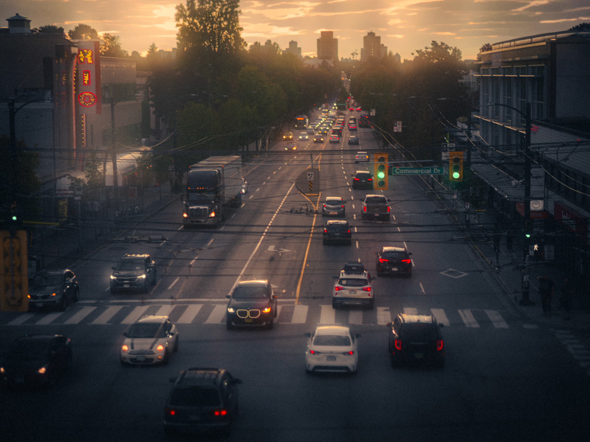 Filmic sunset over Commercial Broadway skytrain station and the RIO theatre
