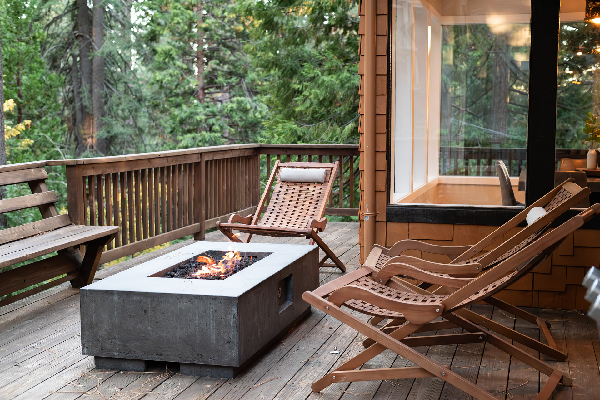 Real estate media capturing private outdoor deck with gas firepit and lounge seating in mountain cabin rental - Andrew Crippen Visuals