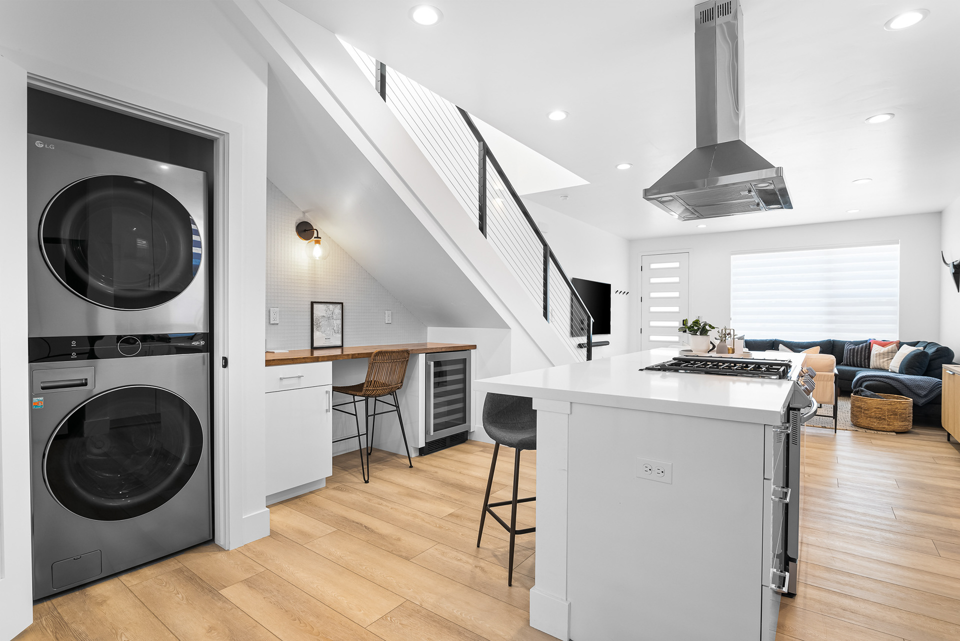 Interior real estate photography of modern kitchen featuring integrated laundry station and built-in study nook in Murrieta city home - Andrew Crippen Visuals