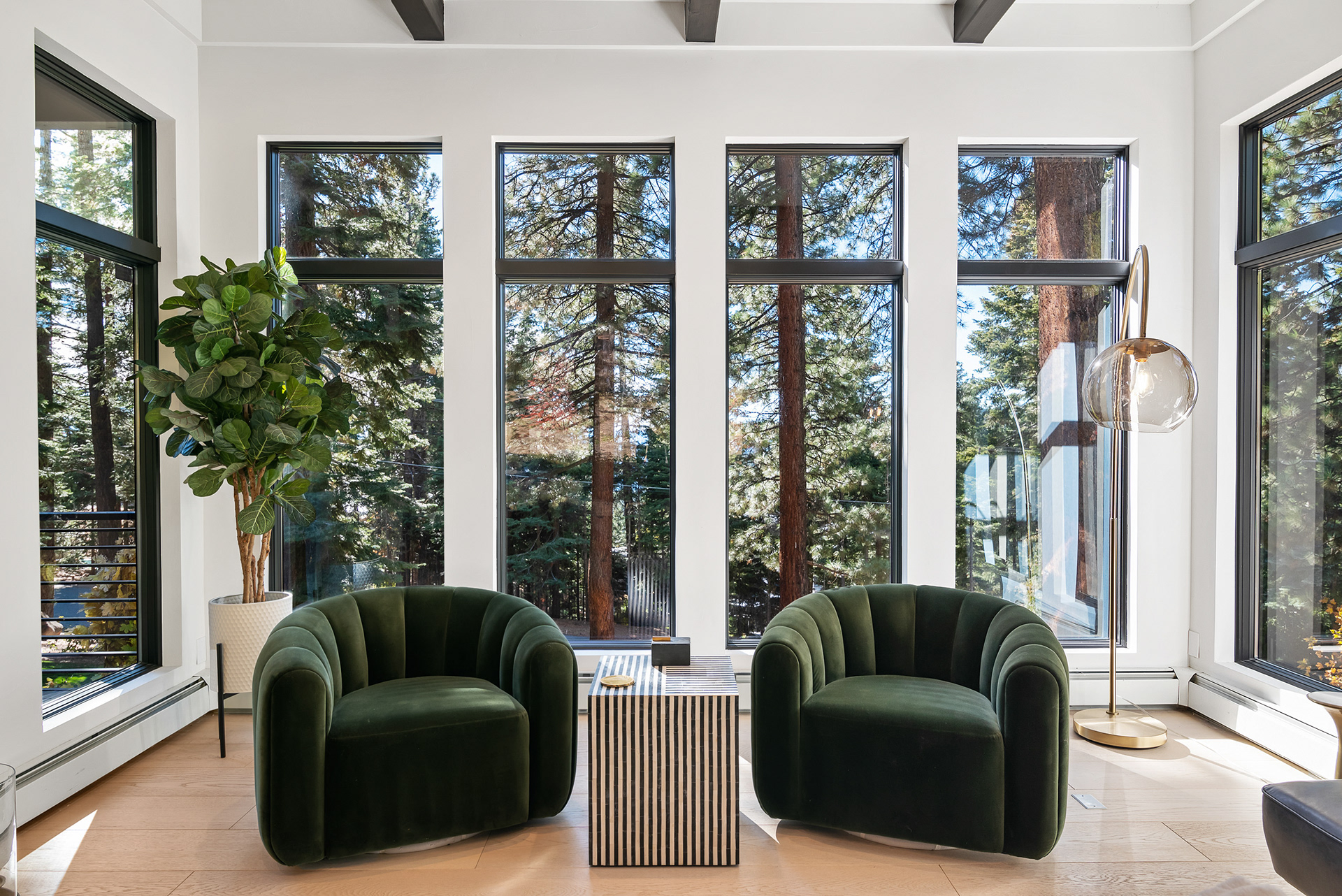 Detail photography of cozy seating nook next to large picture windows in modern forest home - Andrew Crippen Visuals