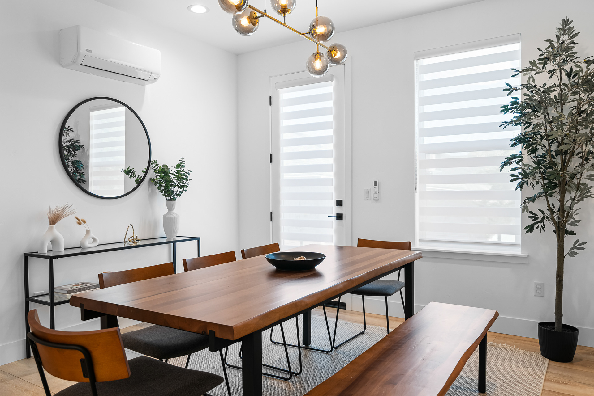 Modern dining room photography showcasing custom wood table and architectural lighting design in Murrieta city home listing