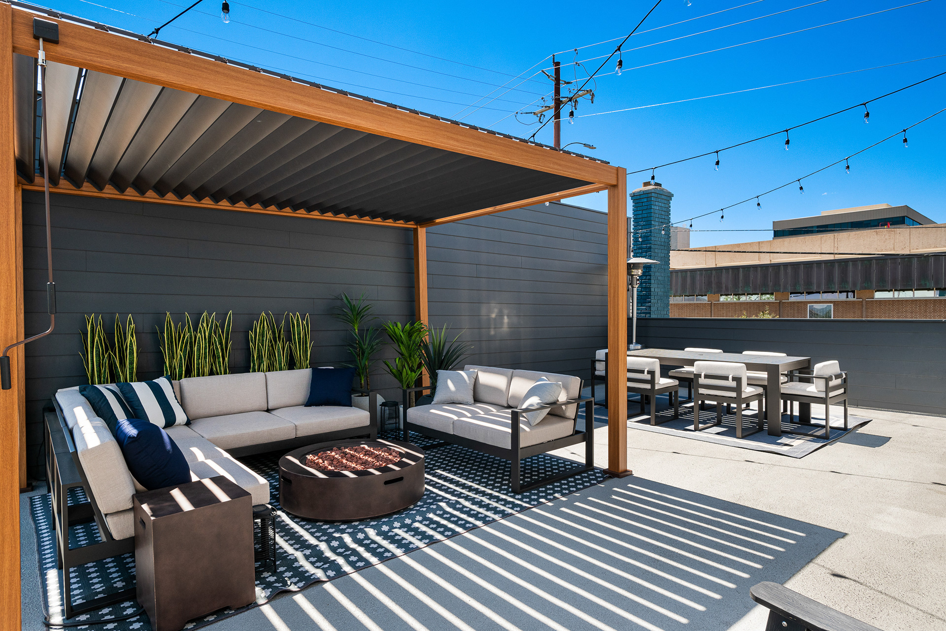 Real estate photography of second-story outdoor dining area and lounge featuring a modern pergola in Temecula city home - Andrew Crippen Visuals
