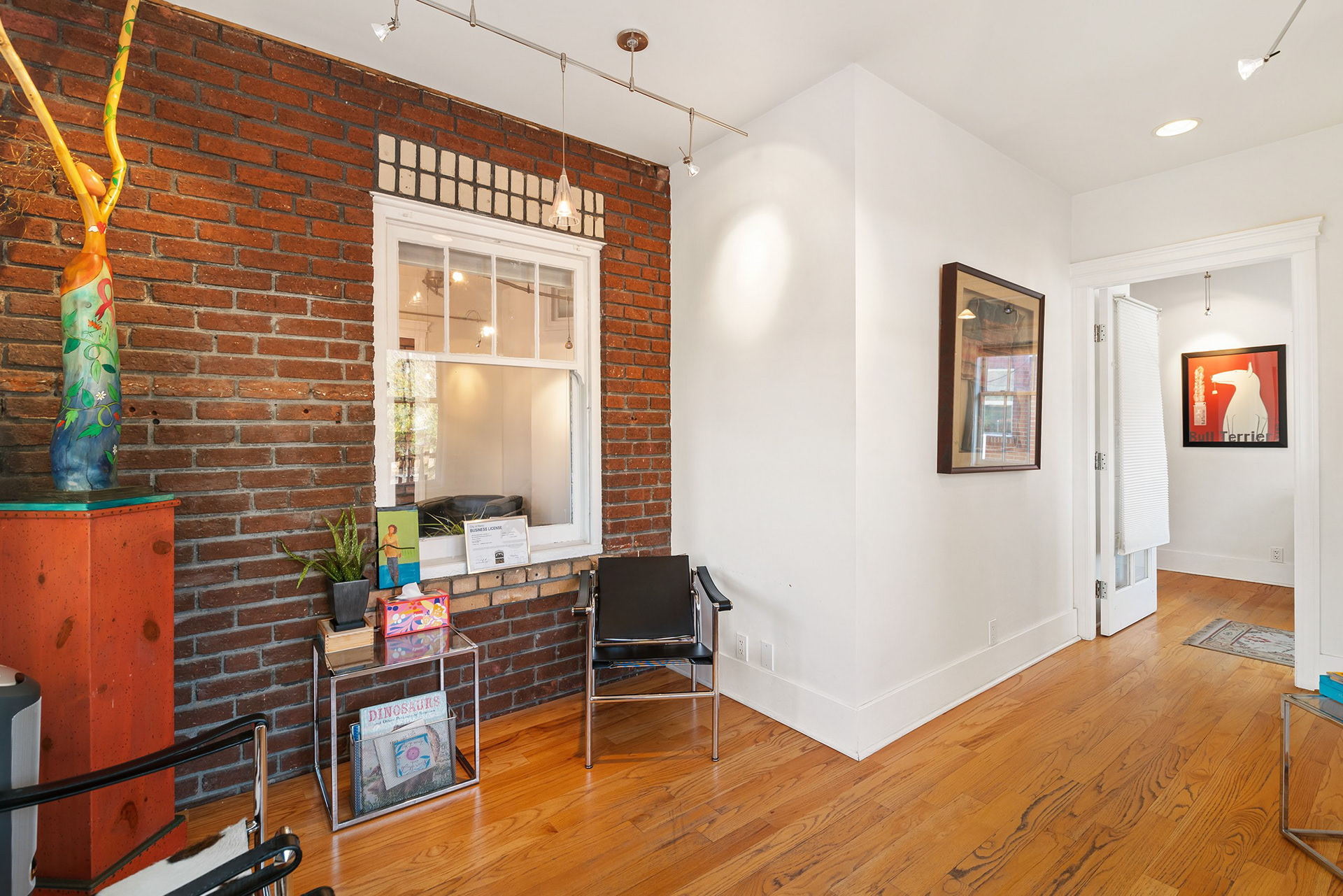 Reception area with exposed brick in a converted office