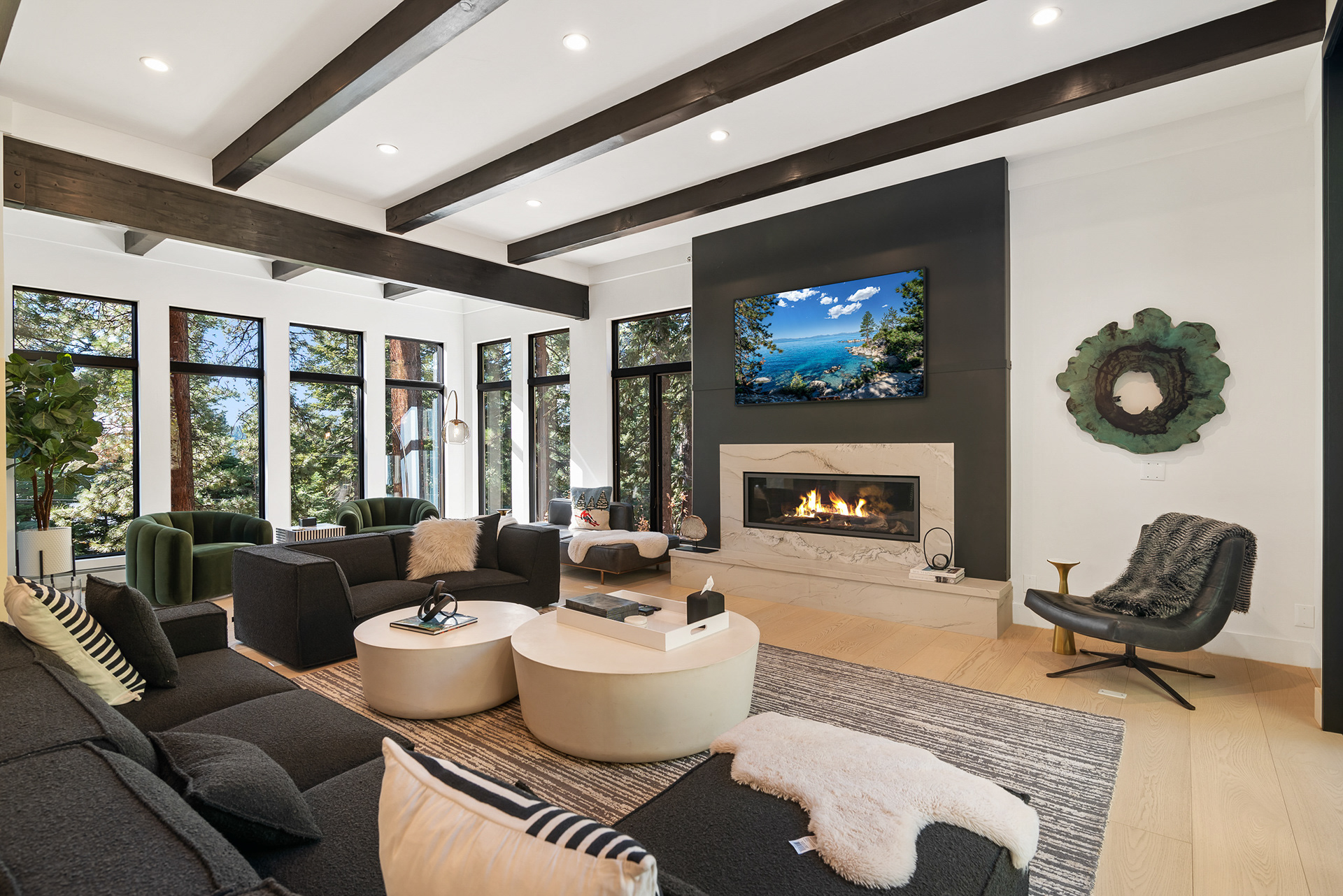 Interior photography of expansive modern living room featuring floor-to-ceiling windows and forest views in luxury vacation rental - Andrew Crippen Visuals