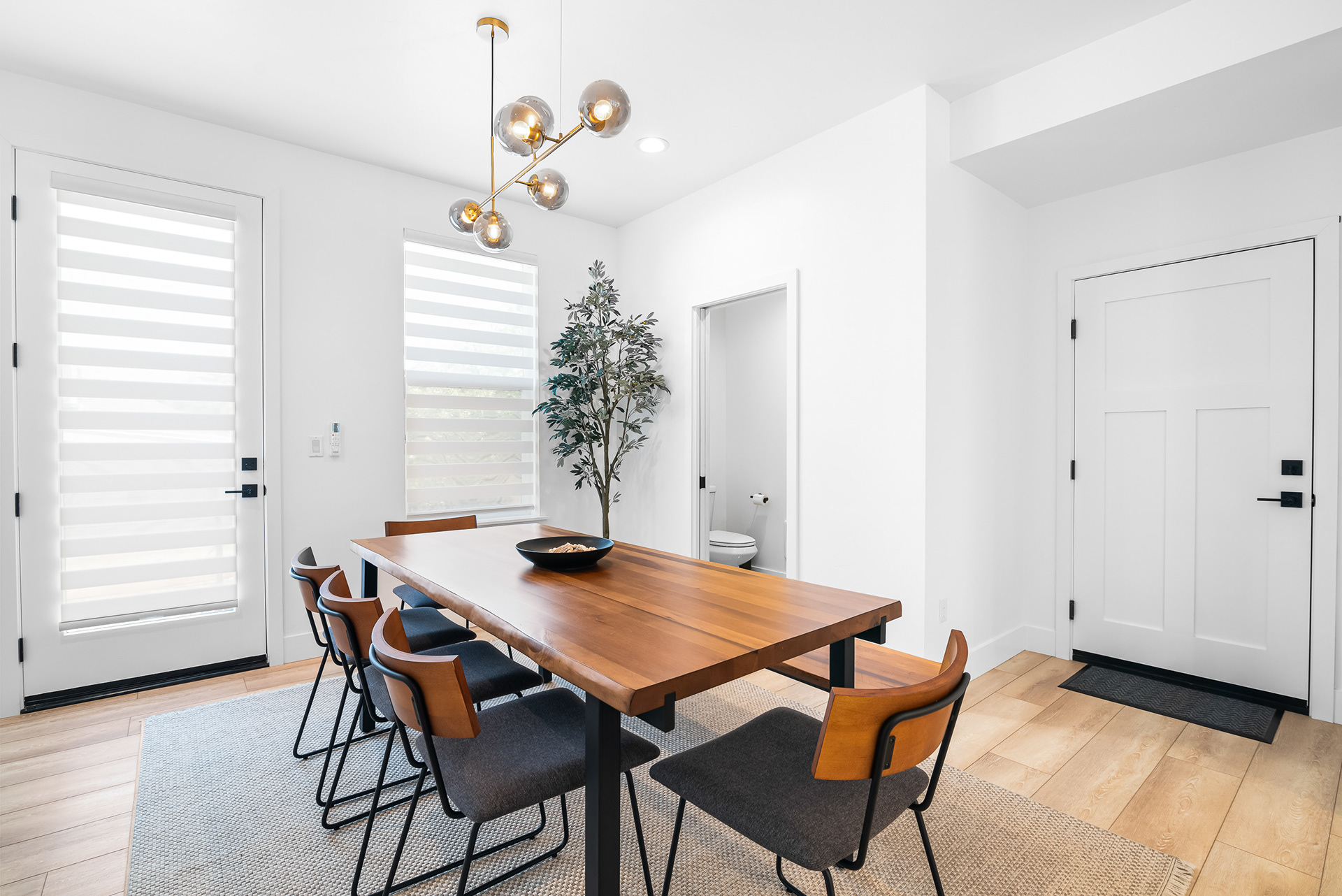 Modern dining room photography showcasing custom wood dining table and architectural lighting design in Murrieta city home listing