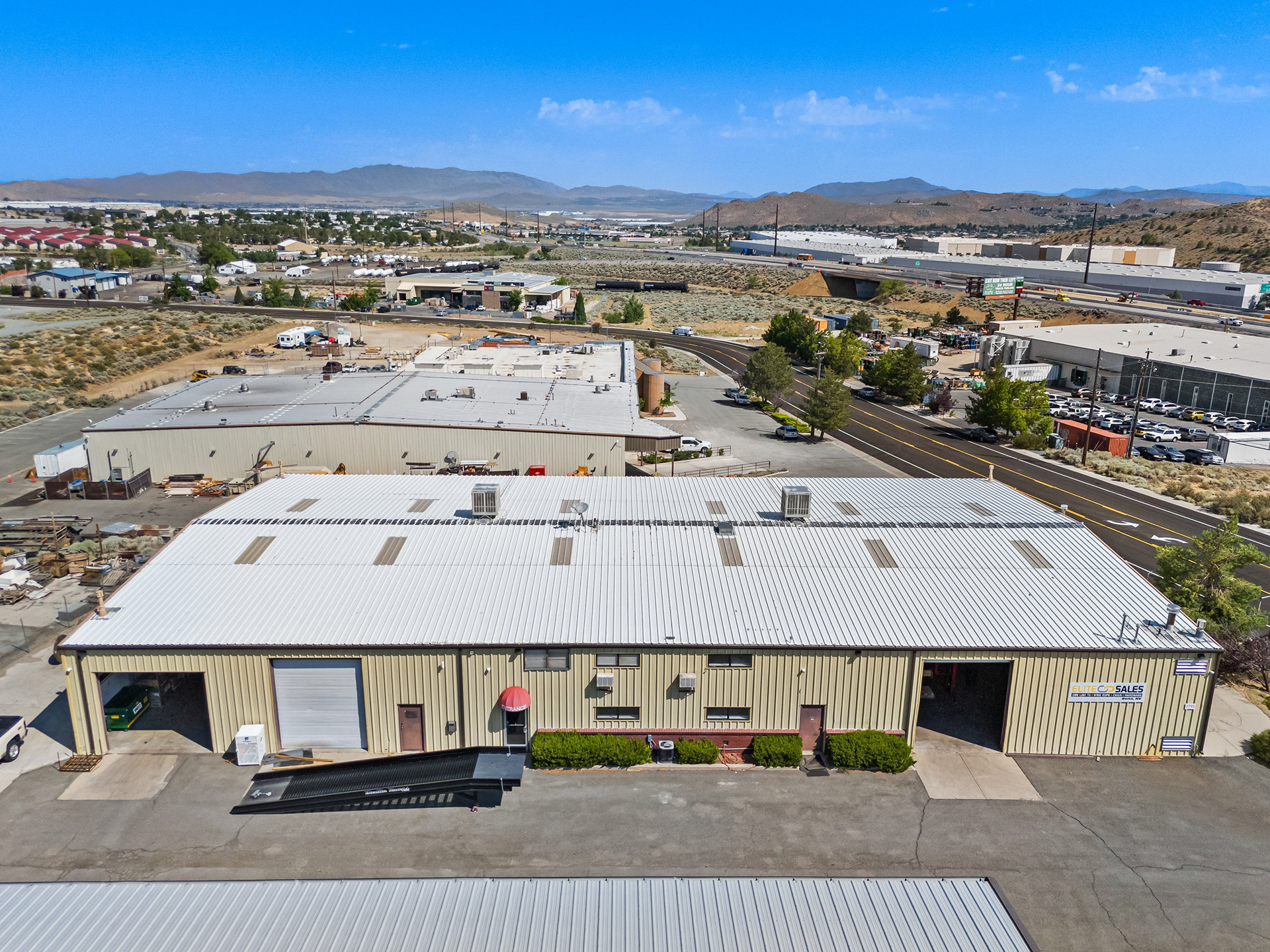 Aerial of an industrial building with roll-up doors and yard