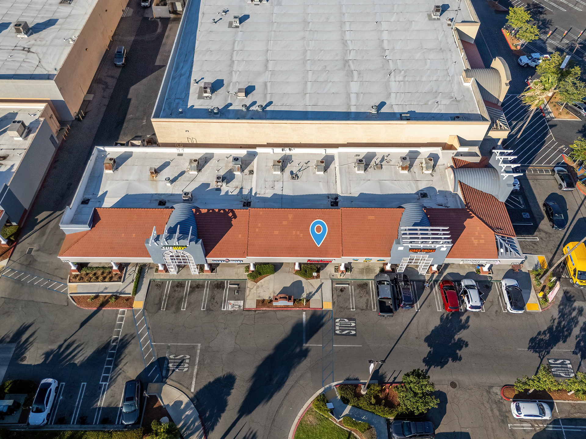 Overhead aerial of a retail building, rooftop, and parking in Temecula, CA