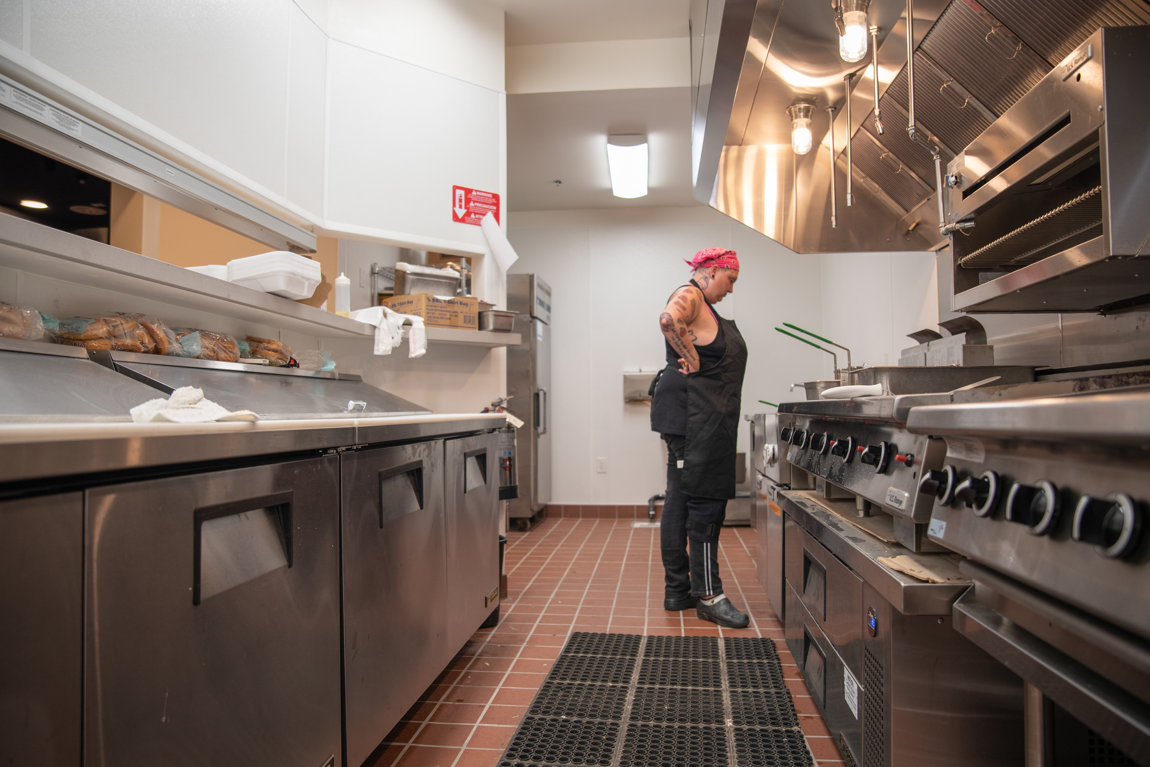 Samantha Bourgeois cooks food at Sidetraxx, a night club, in Sacramento, Calif. on July 21, 2021. Bourgeois was hired as a main cook for the club’s weekly events. 