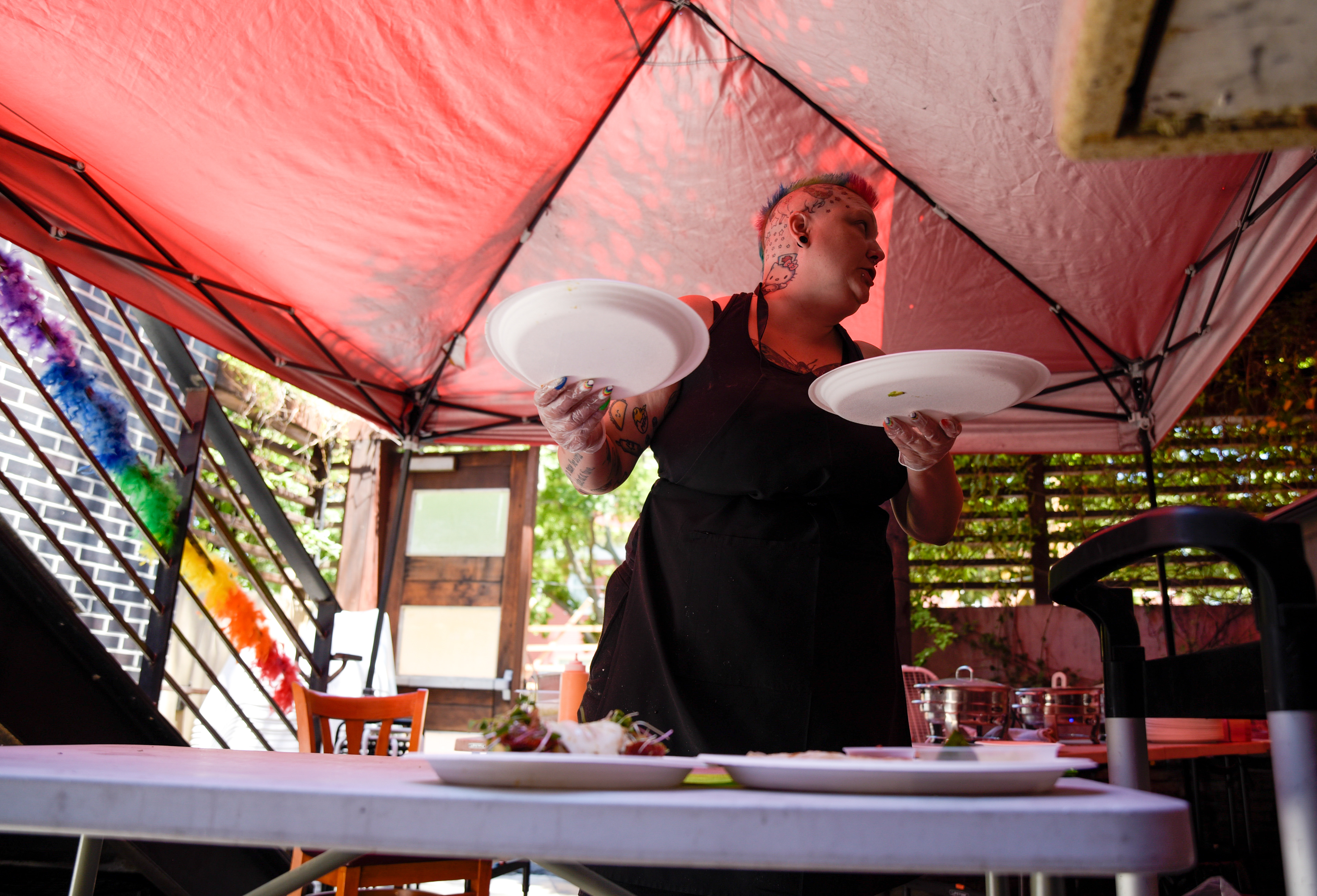  Samantha Bourgeois readies plates of food for the Makeup & Mimosas Drag Brunch show at Badlands in Sacramento, Calif. on June 27, 2021. Bourgeois was hired as a weekend cook and prepares brunch items for the club’s show. 