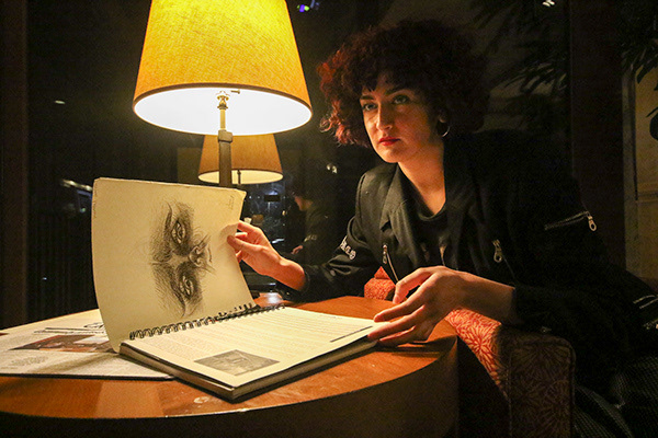 Cartoonist Ivana Amaral reviews her sketches under in the lobby at the DoubleTree by Hilton Hotel in Sacramento, Calif. on March 28, 2019. Amaral’s first semester on the staff of the East Los Angeles College Campus News has motivated her to start drawing again after years away from the sketchbook.