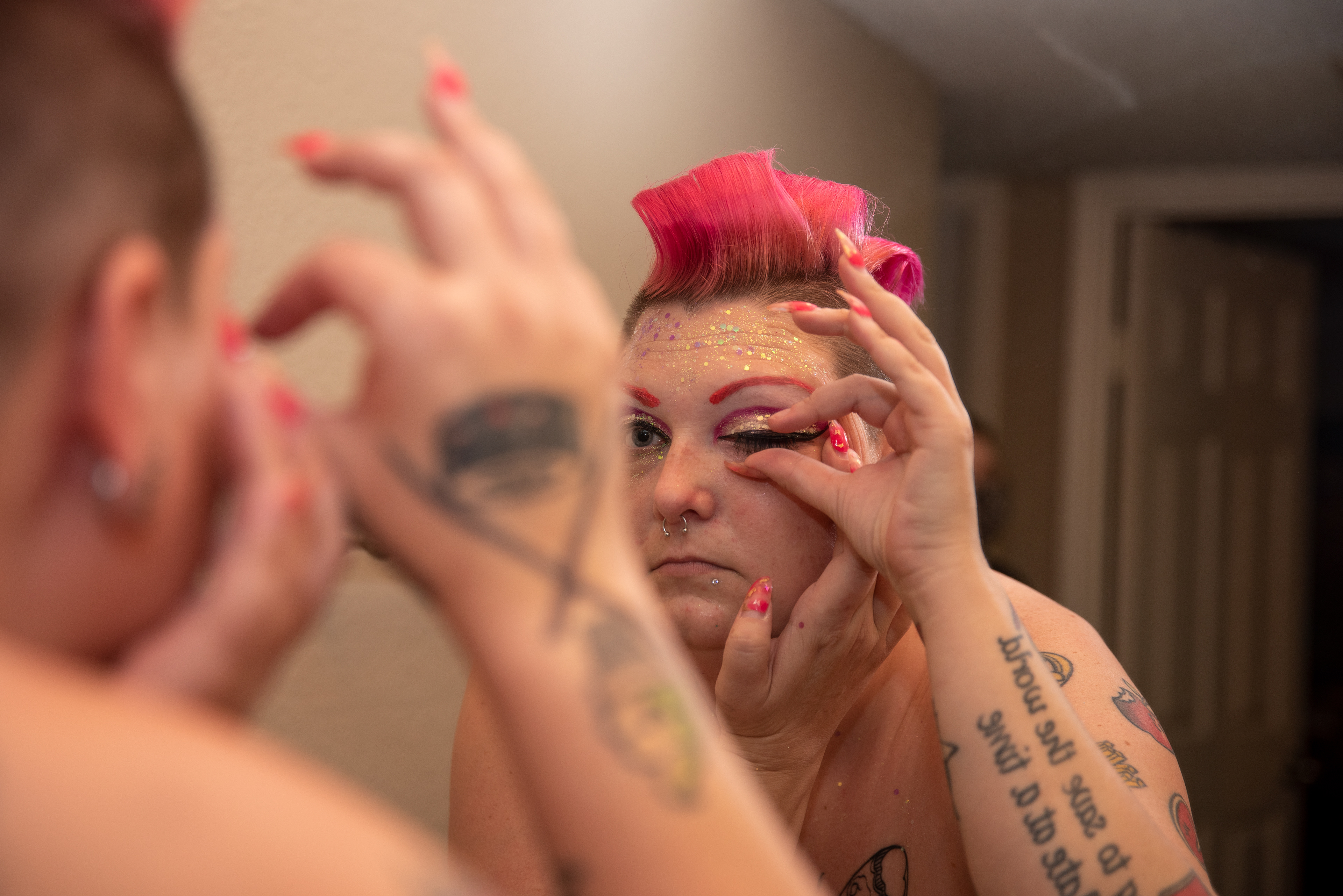 Samantha Bourgeois puts on fake eyelashes before making content for their OnlyFans page in their apartment located in Sacramento, Calif. on Aug. 18, 2020. Bourgeois says that it’s expensive to be a sex worker because they have to regularly buy different outfits, restock on makeup and make sure their nails are done. They say that clients will take notice if they wear the same outfit twice or if they don’t have a fresh manicure. 
