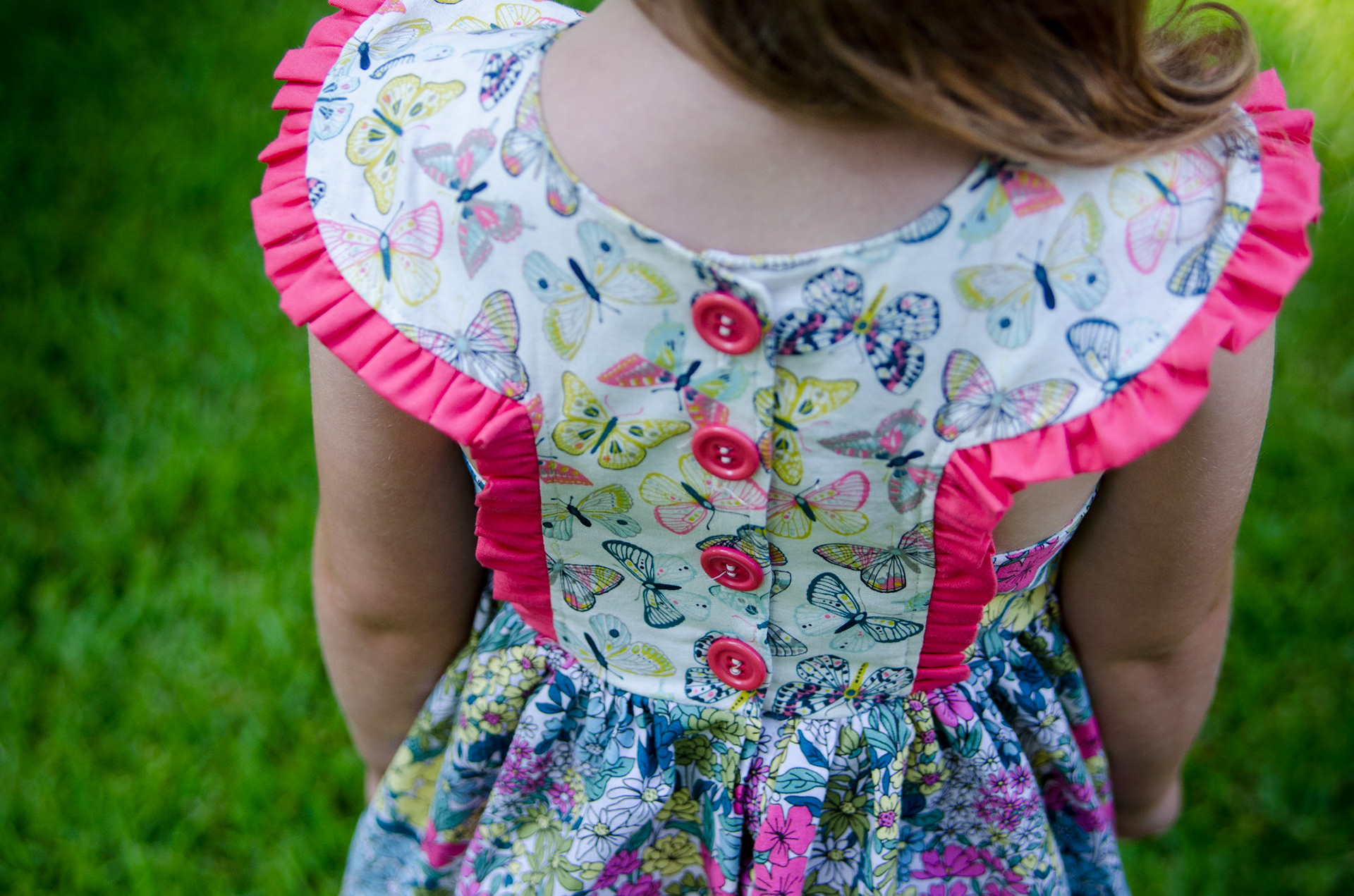 Button placket, yoked dress with ruffle detail.