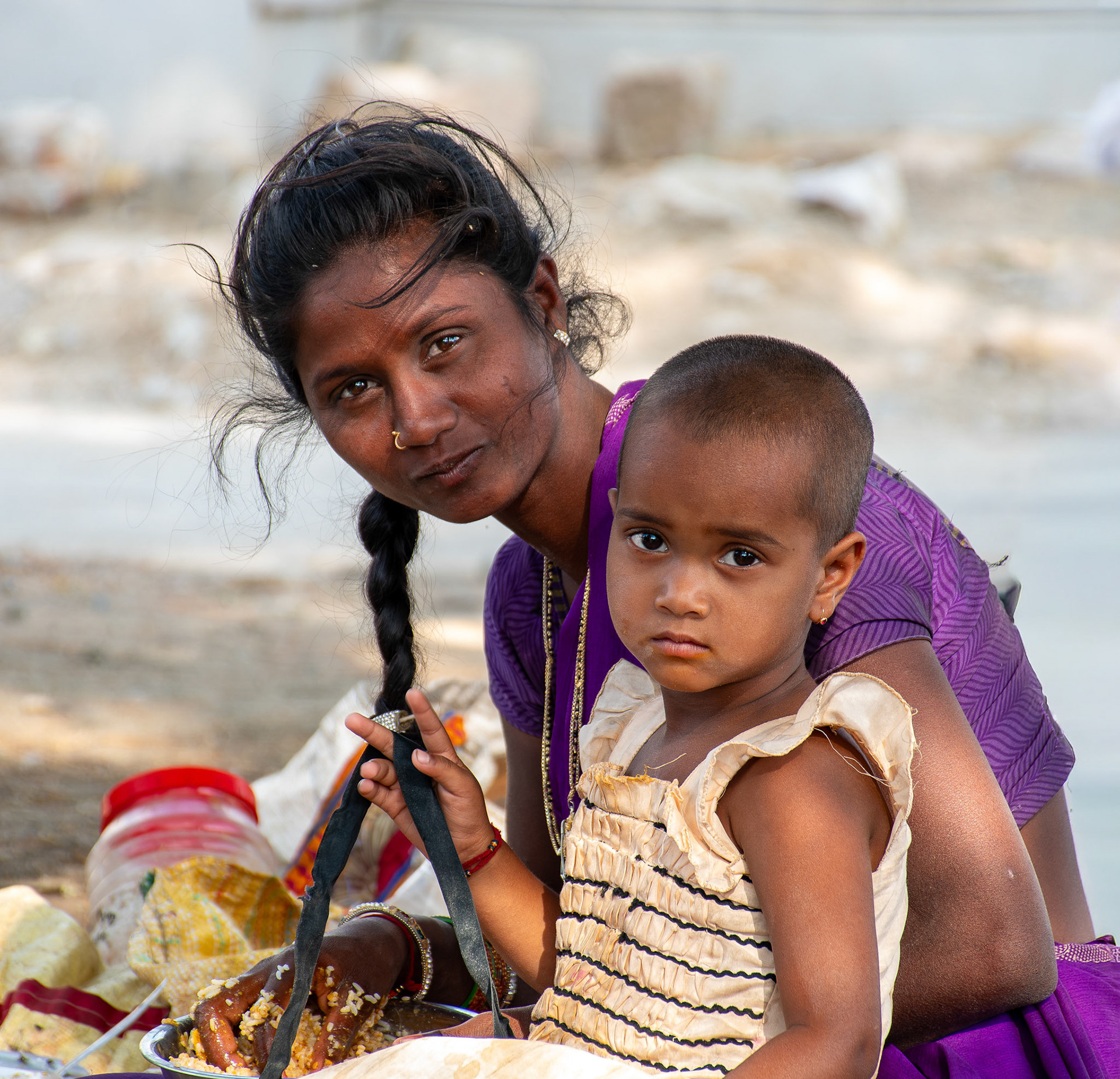 Mother, daughter and a bowl of rice  • India
