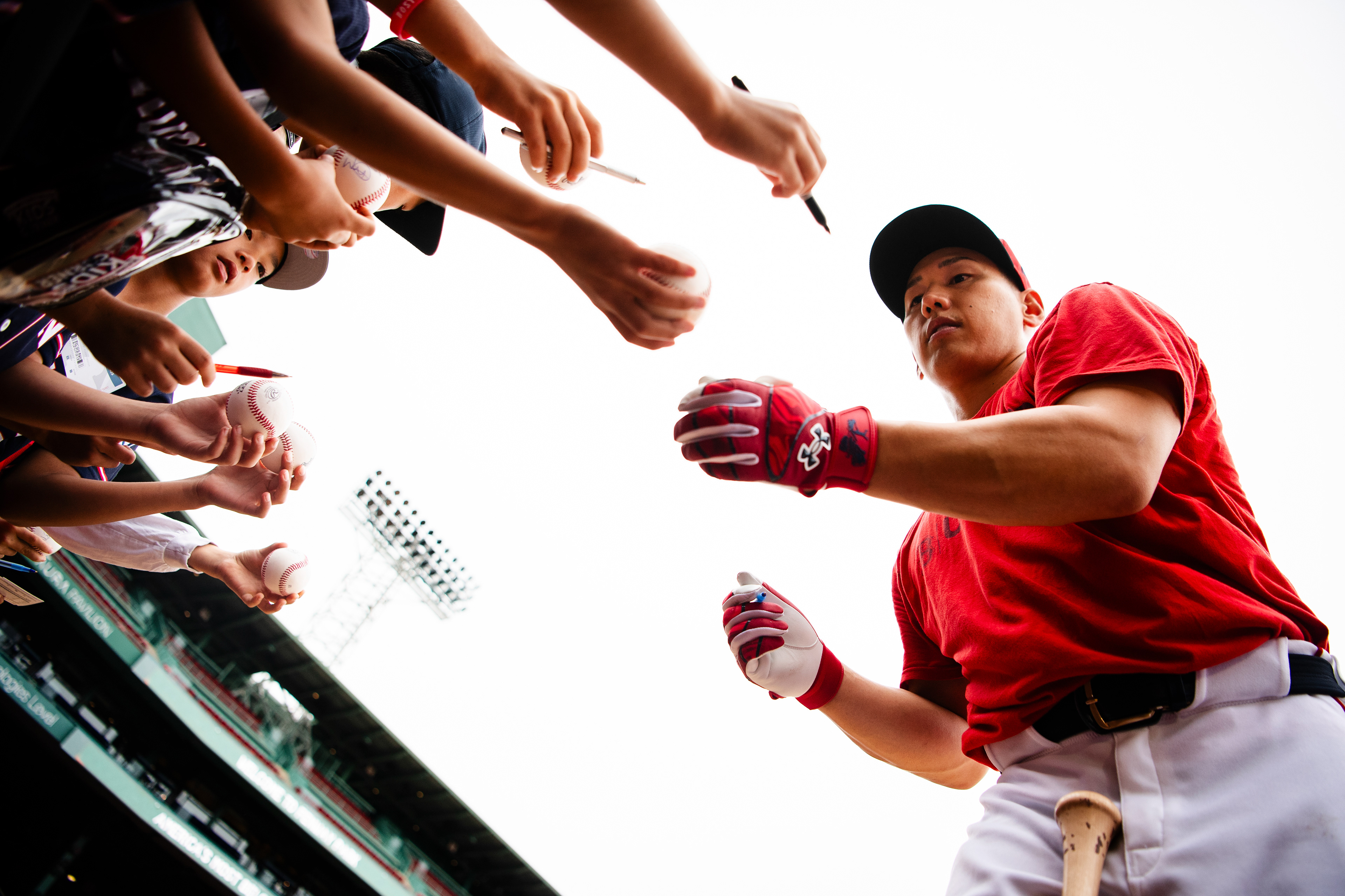 August 6, 2025, Boston, MA: Masataka Yoshida #7 of the Boston Red Sox autographs fans baseballs during batting practice ahead of game against the Kansas City Royals at Fenway Park in Boston, Massachusetts Wednesday, August 6, 2025.  (Photo by Clay Stark/Boston Red Sox)