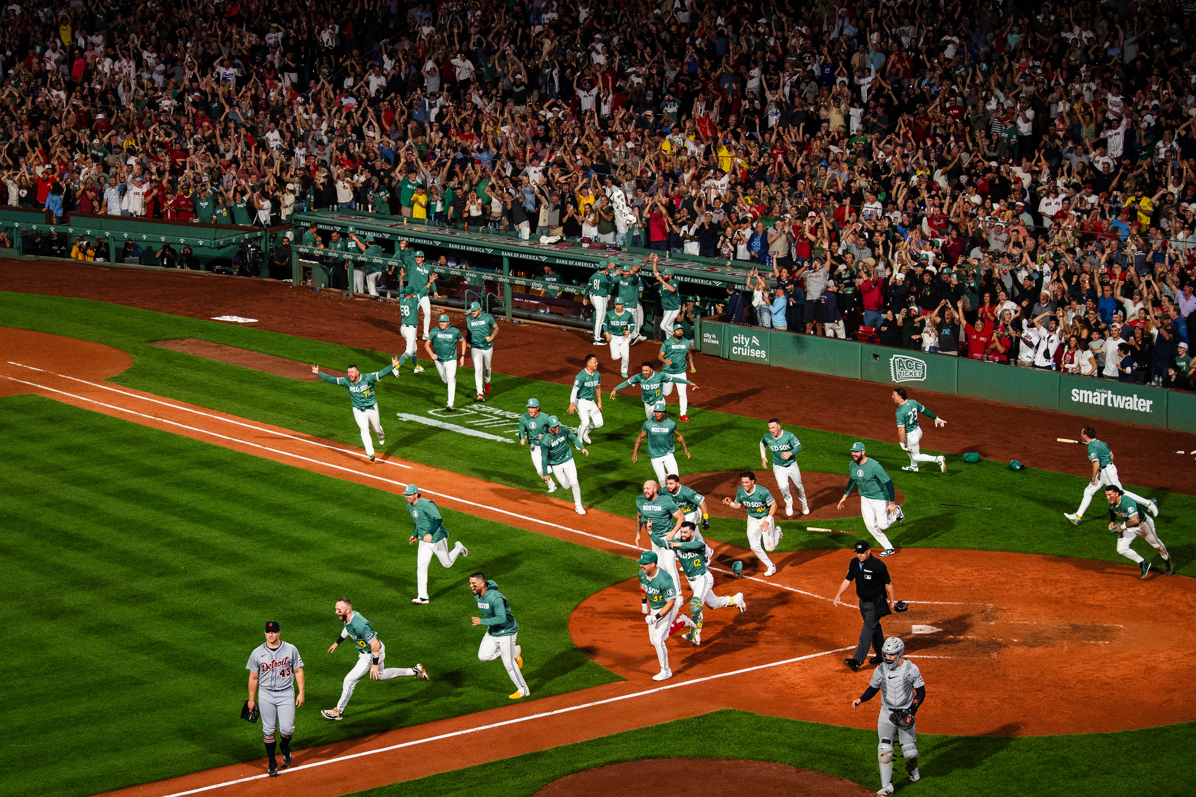 September 26, 2025, Boston, MA: Members of the Boston Red Sox runout to celebrate after Ceddanne Rafaela #3 of the Boston Red Sox hit a walk off triple during the ninth inning to clinch a wild card spot against the Detroit Tigers at Fenway Park in Boston, Massachusetts Friday, September 26, 2025.  (Photo by Clay Stark/Boston Red Sox)