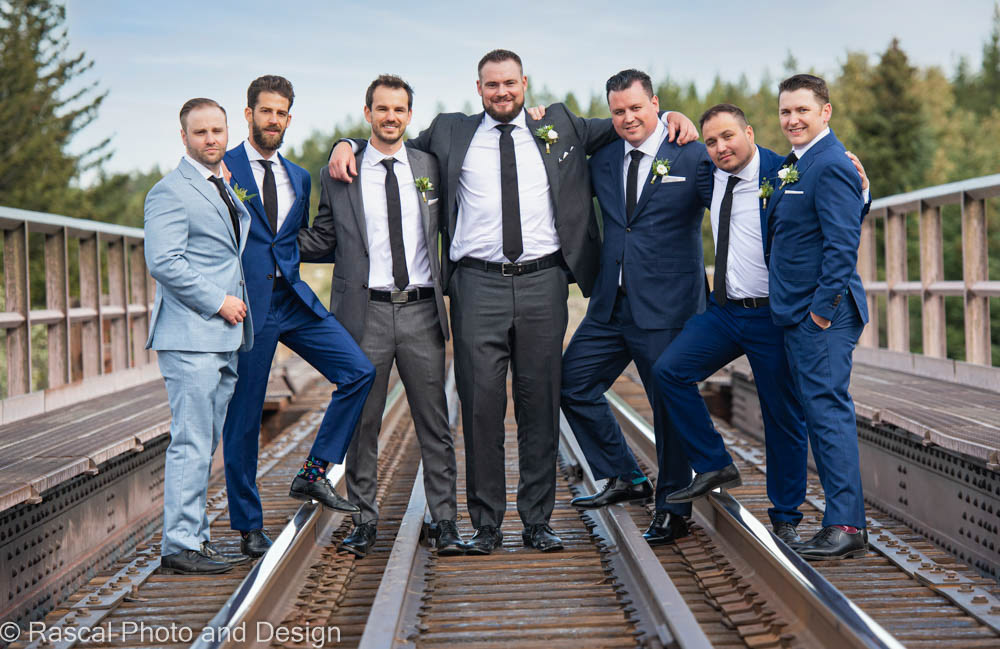 groom and groomsmen on railroad tracks