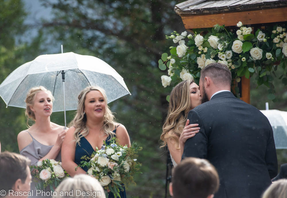 bride and groom kiss at silvertip wedding ceremony