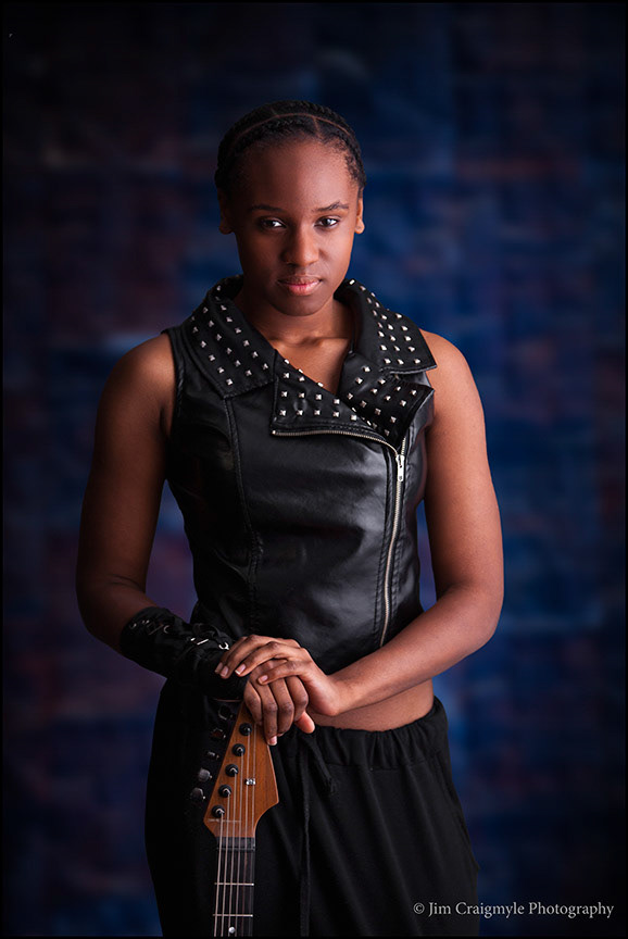 Model and propety released. Teen aged African American musician holding a custom built electric guitar.