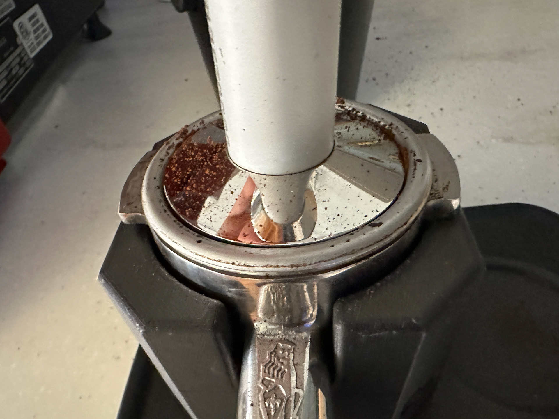 Grounds can often escape around the edge of the tamper, especially when the pile of grounds can't be tapped and leveled before being tamped