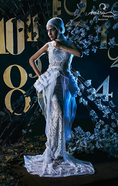 Dramatic studio portrait featuring bold contemporary styling, textured fabric details, and directional lighting