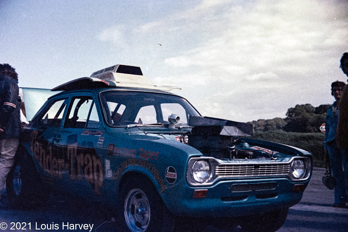Former Radio One DJ Dave Lee Travis with his Ford Escort drag car 'Tender Trap' (1975)