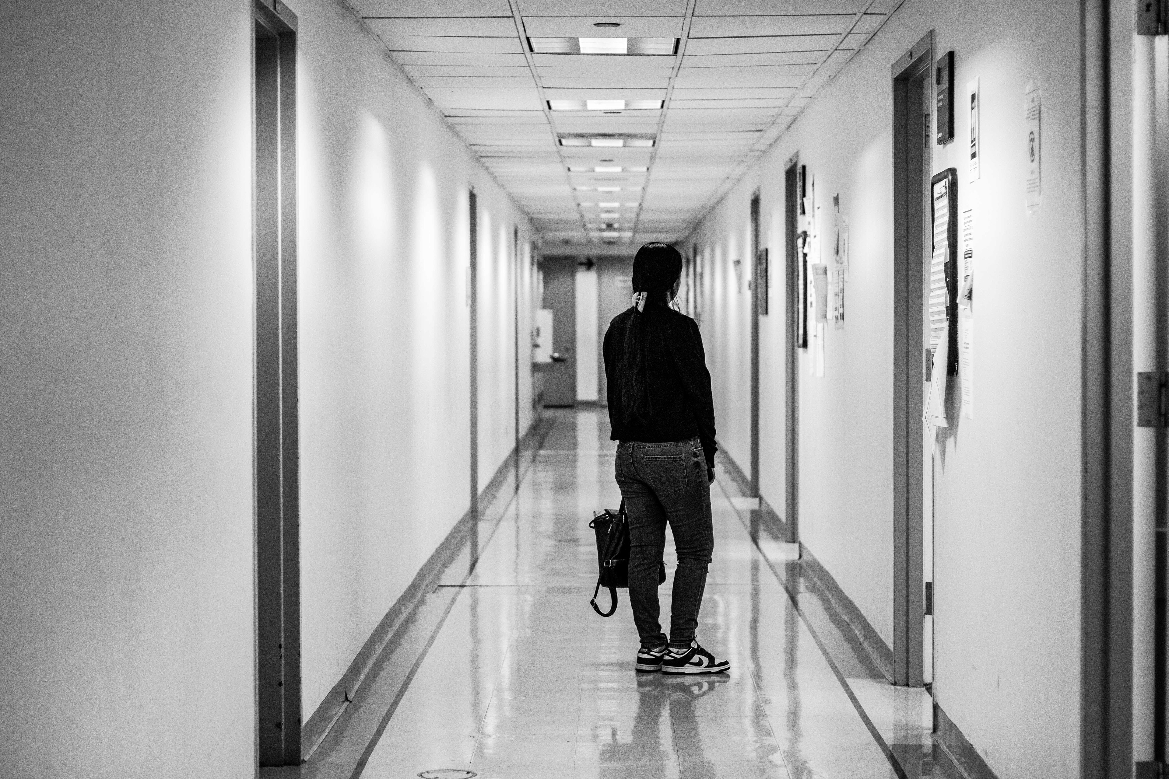A migrant waits in the empty hallways outside a court room. When ICE leaves for the day, the hallways once again return to a tranquil state.