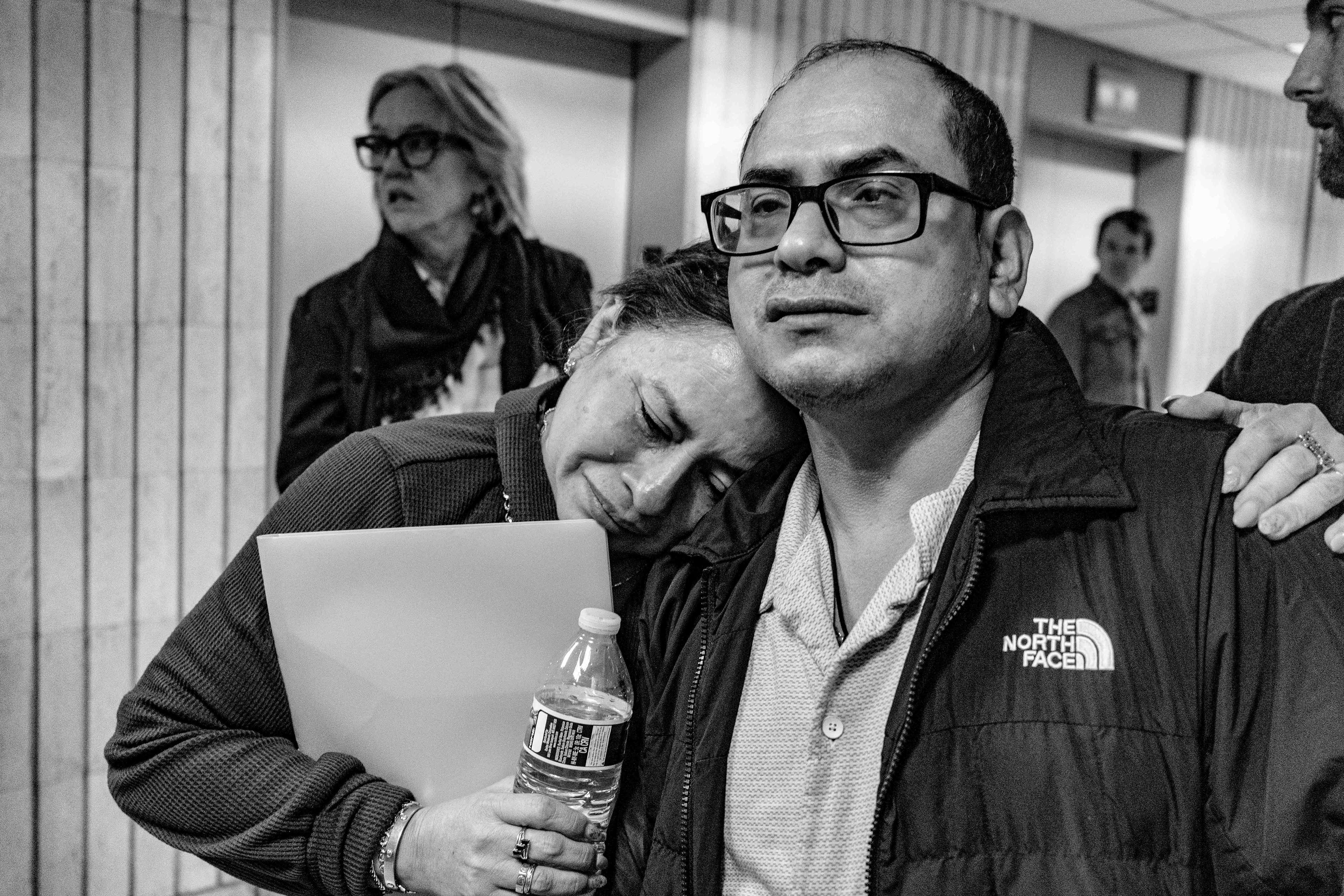 A woman hugs her family member after his court appointment. She told the press, that she was worried he would be detained by federal immigration agents.