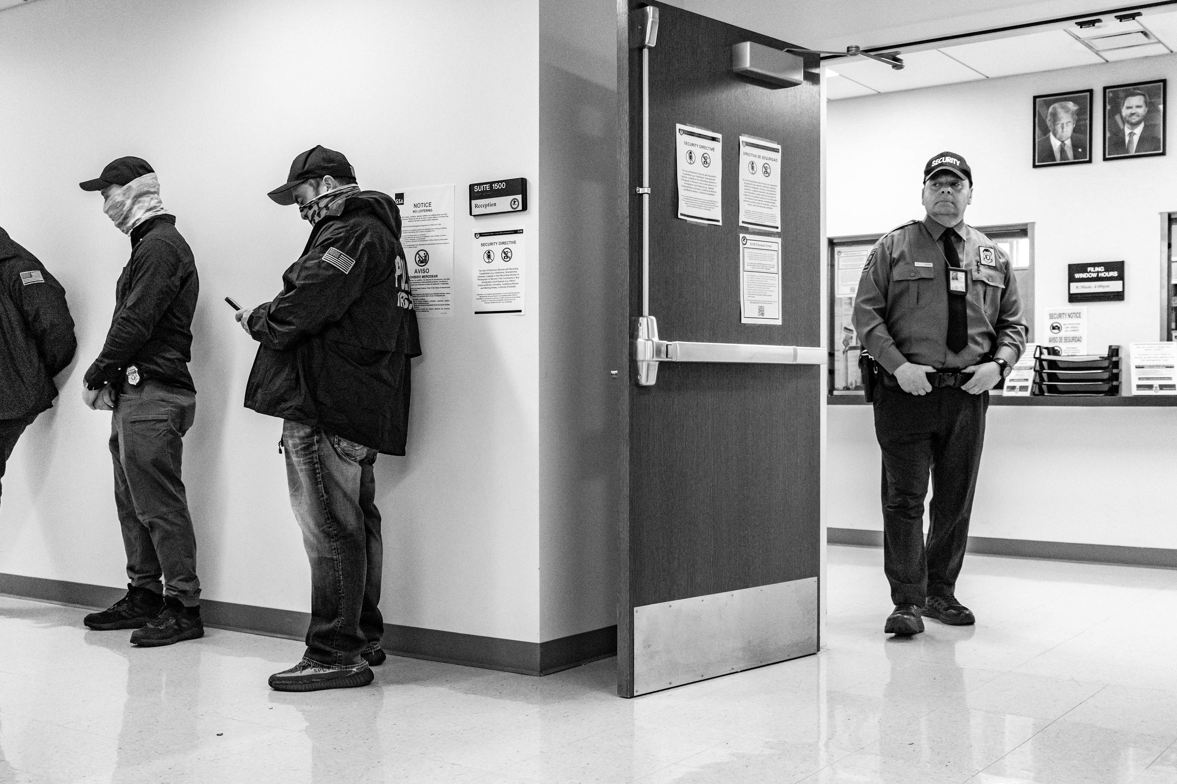 Federal agents wait outside of a courtroom in 290 Broadway. 