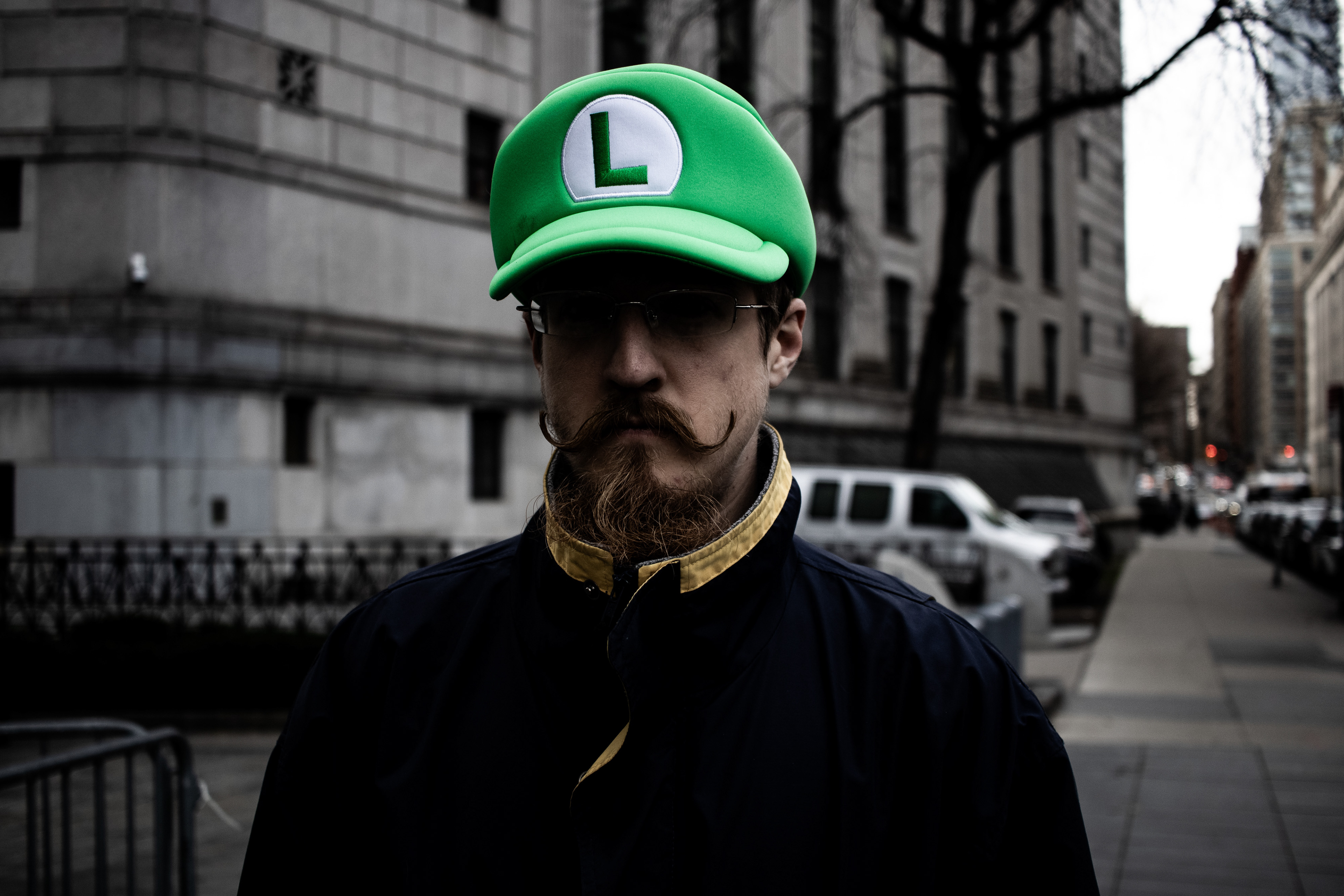 A Luigi Mangione supporter stands outside of Luigi's initial arraignment in New York, New York on December 19th, 2025. Mangione's killing of United Healthcare CEO Brian Thompson ignited debate over health insurance throughout the country.