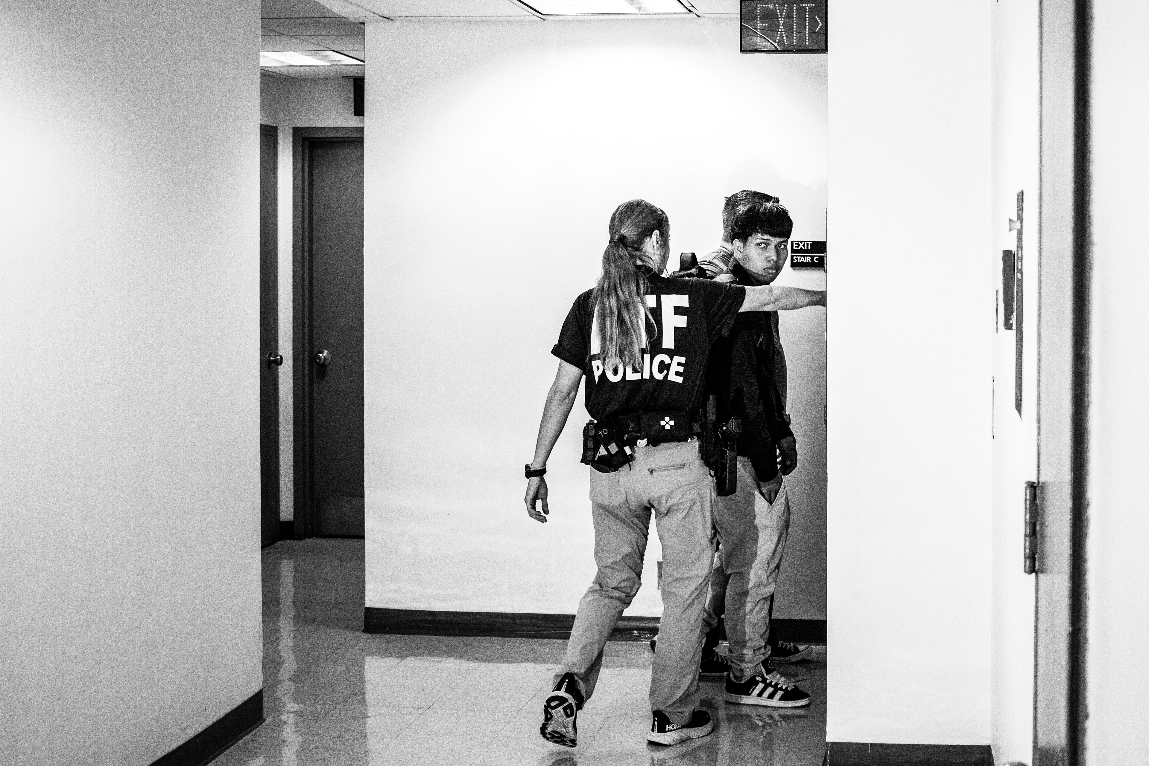 federal agents escort a young male to a side stairwell; He would be released a few minutes later. Agents would often question or detain migrants in areas like the side stairwells, out of sight of any Cameras. 