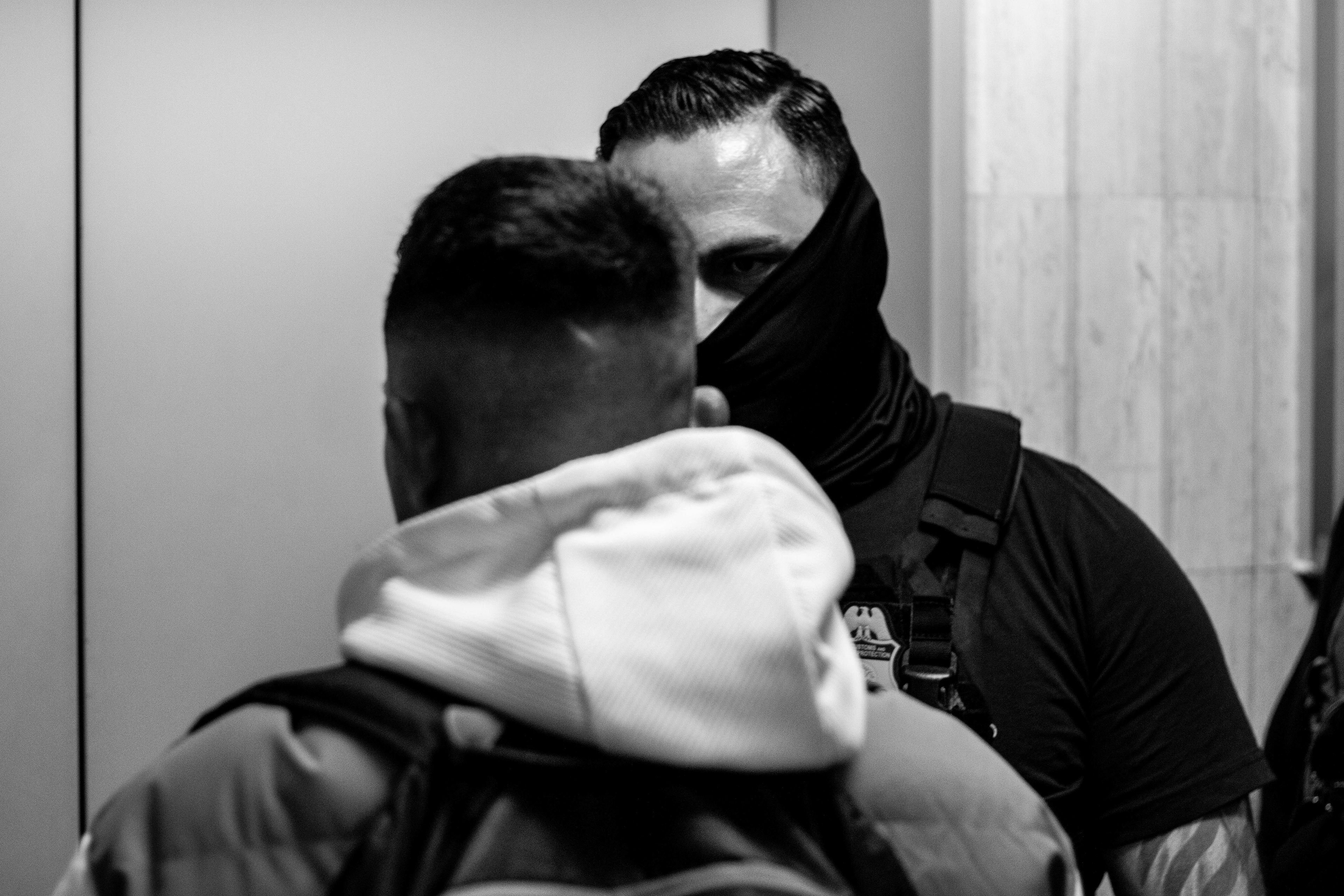 A federal agent stares down a respondent. 