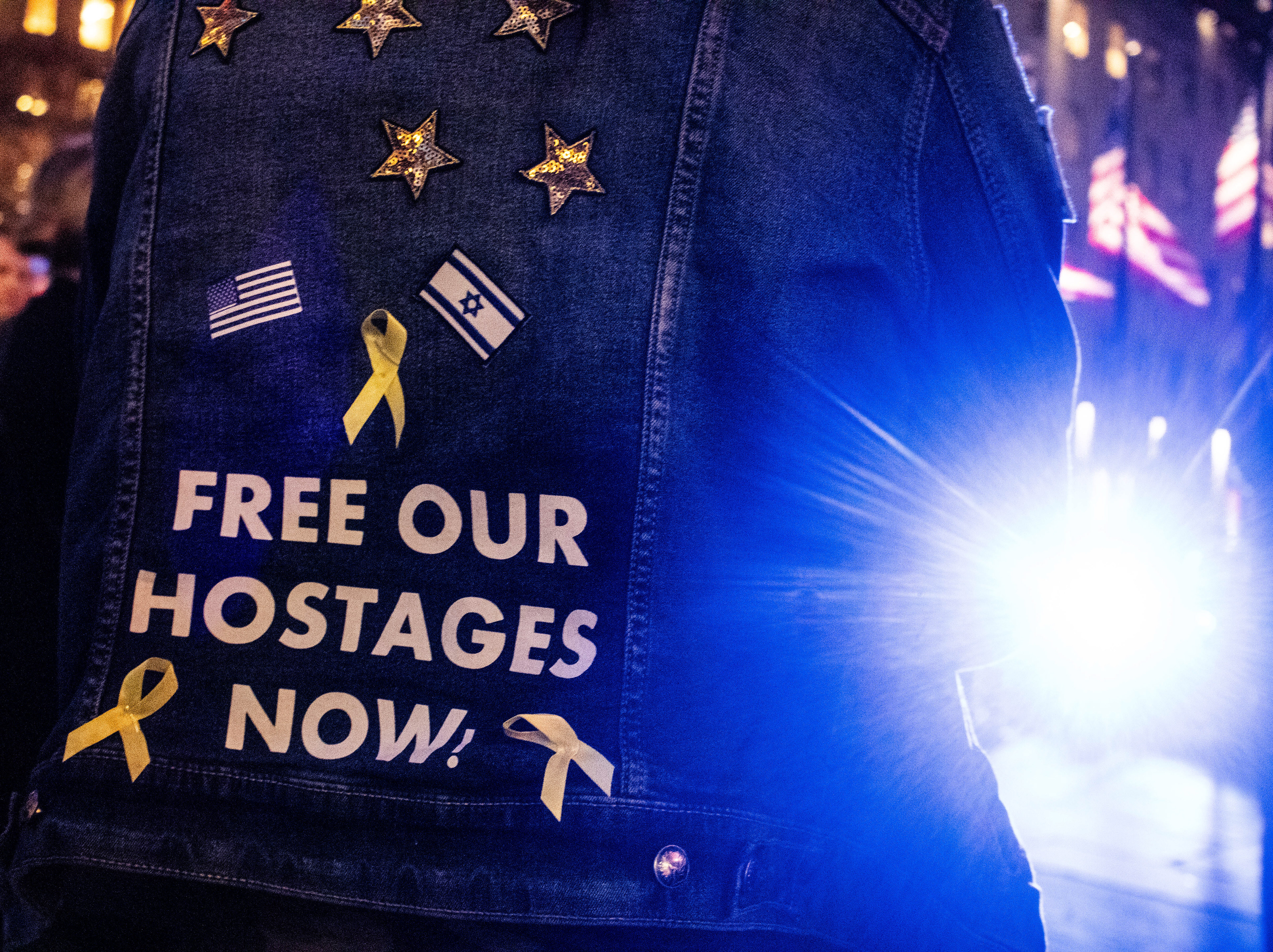 A viewer of an election watch night party at Rockefeller Center dons a "Free Our Hostages," shirt in New York, New York on November 5th, 2025. Donald Trump would go on to become the 47th president of the United States.