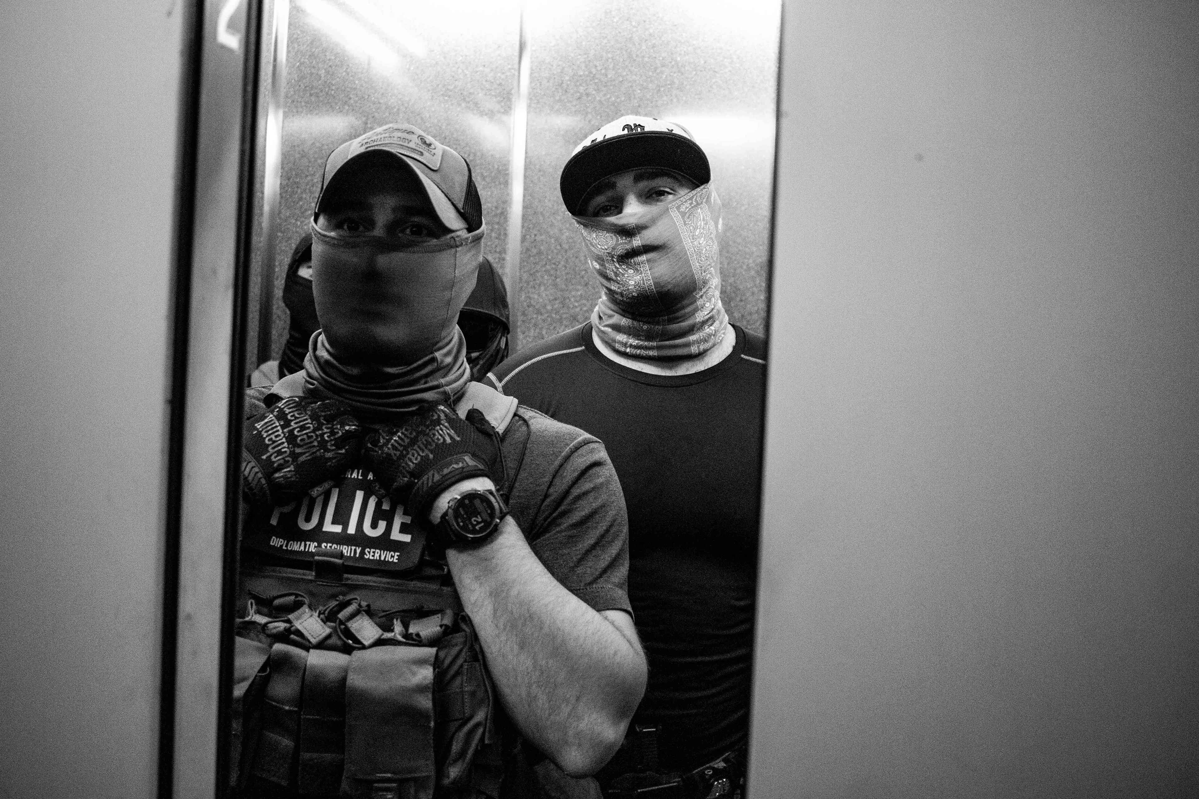 Federal agents waiting in the elevator at 26 Federal Plaza.