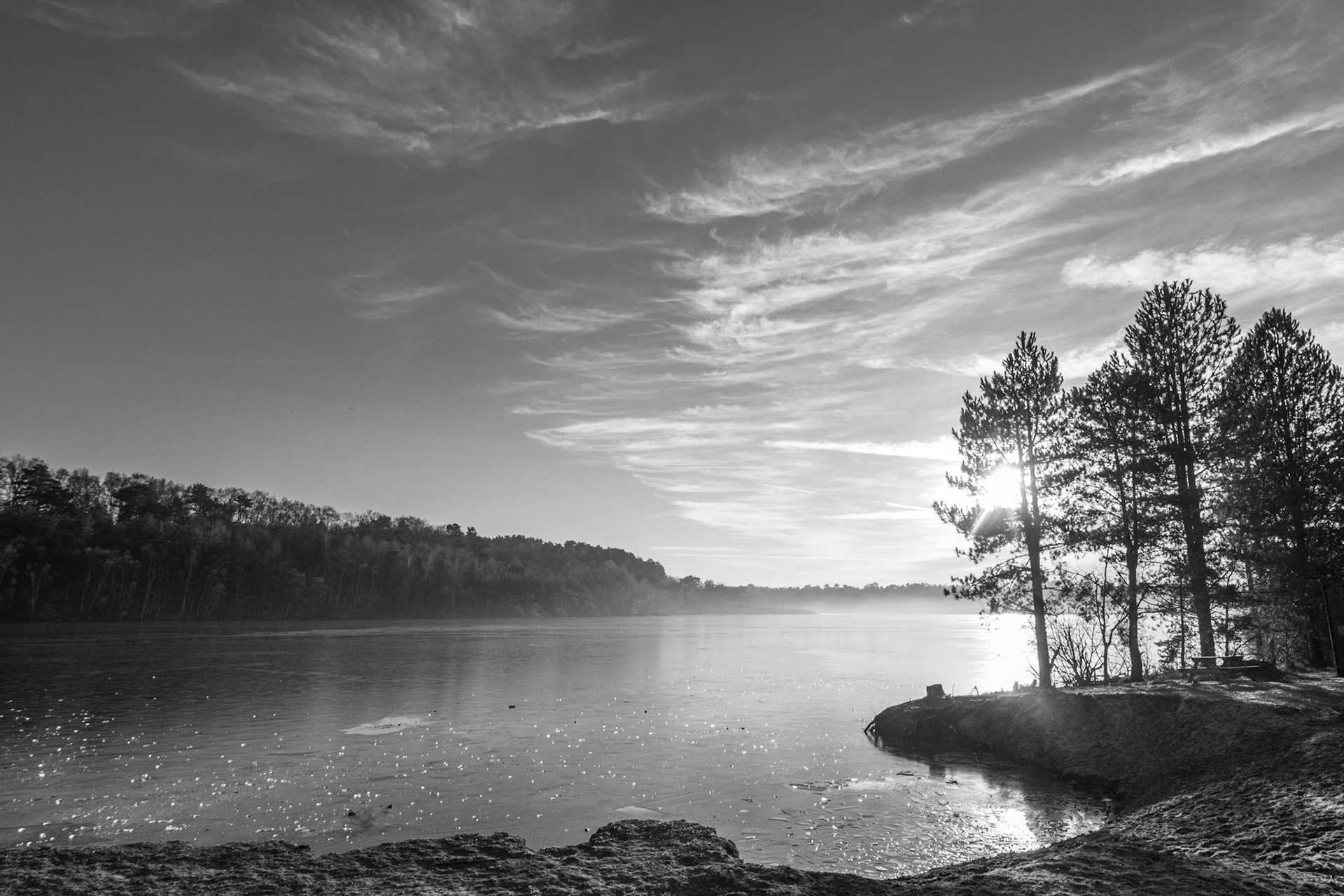 Iced over lake with late winter sun