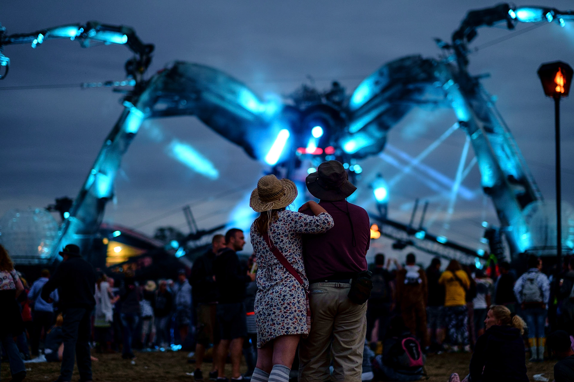 Arcadia at Glastonbury Festival at Worthy Farm on 27/06/2015 at Worthy Farm, Glastonbury.  A couple stand back, arm in arm and watch Arcadia at dusk. Picture by Julie Edwards