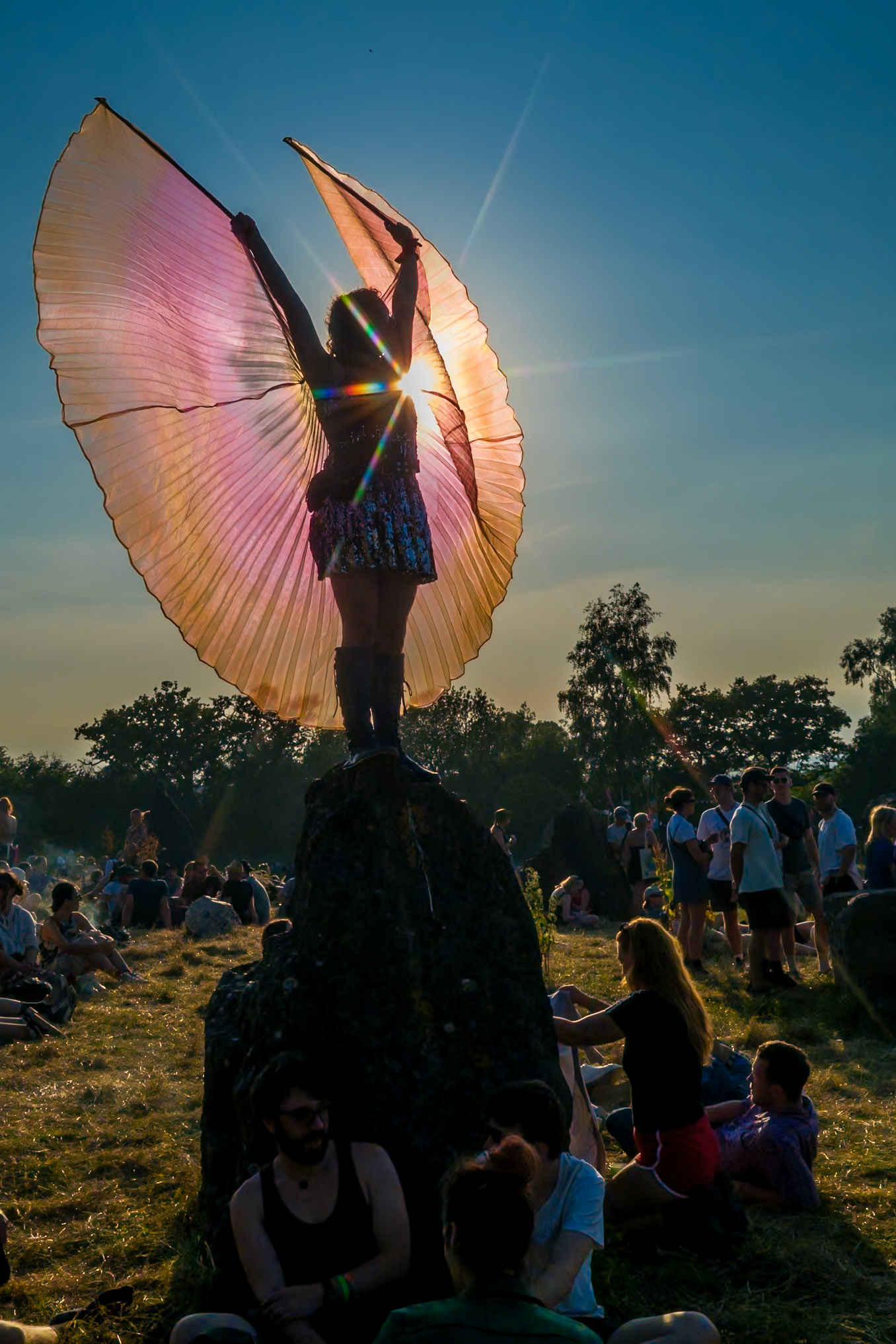 Atmosphere at the Stone Circle as a person dances on a stone with wings during 2024 Glastonbury Festival on Wednesday 26 June 2024 at Worthy Farm, Glastonbury. Editors Note: Image shot with a star filter attached to the camera. Picture by Julie Edwards/LFI/Avalon. All usages must be credited Julie Edwards/LFI/Avalon.