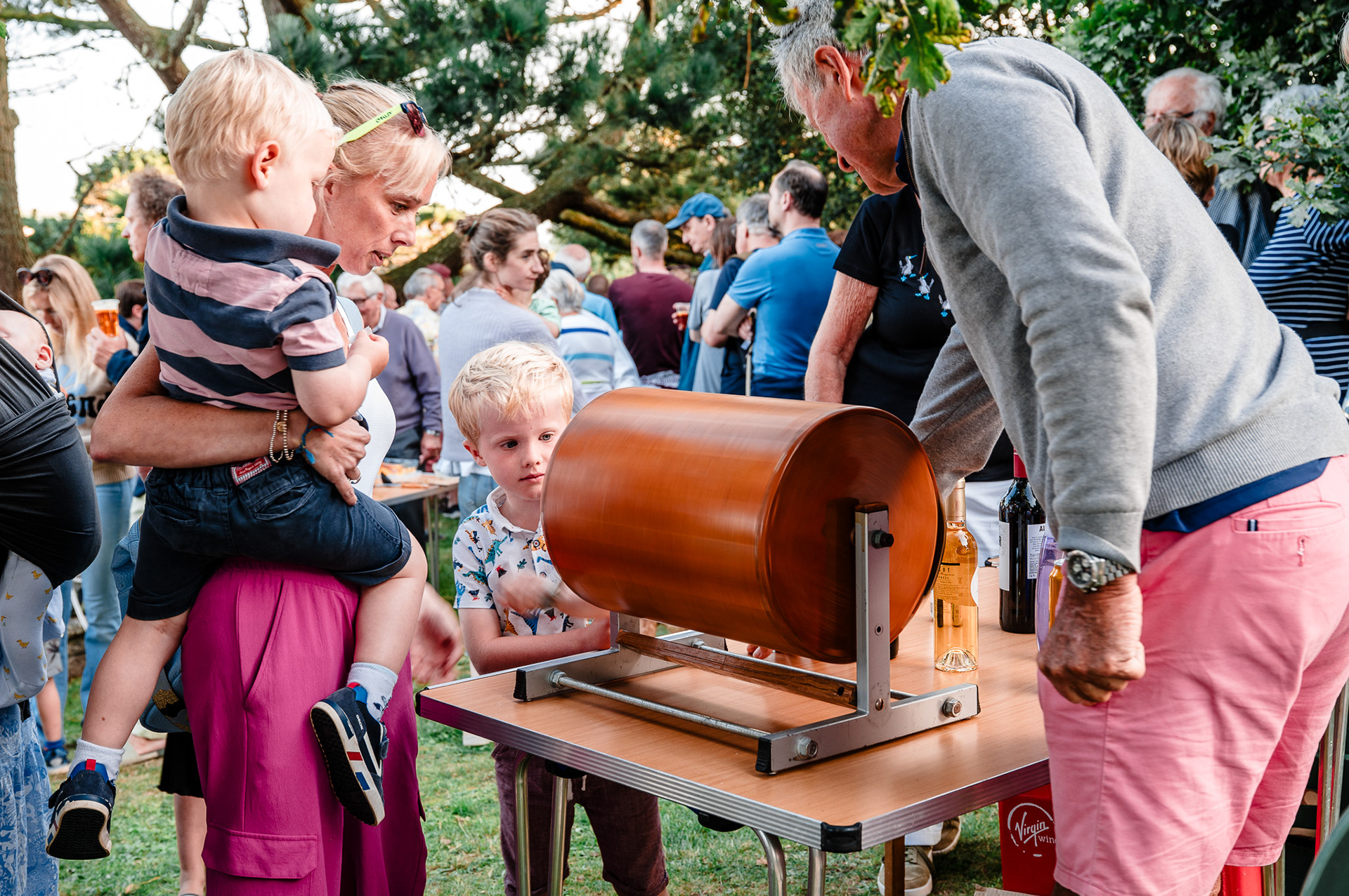 A young boy spins a tombola at a Devon church fete.