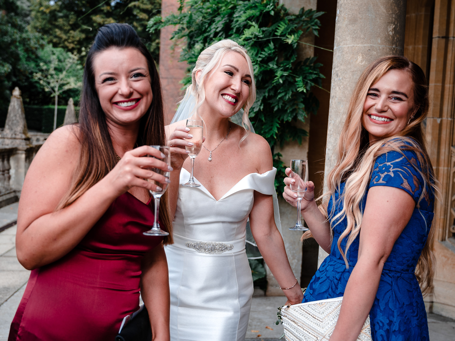 The bride and two friends smile for the camera.