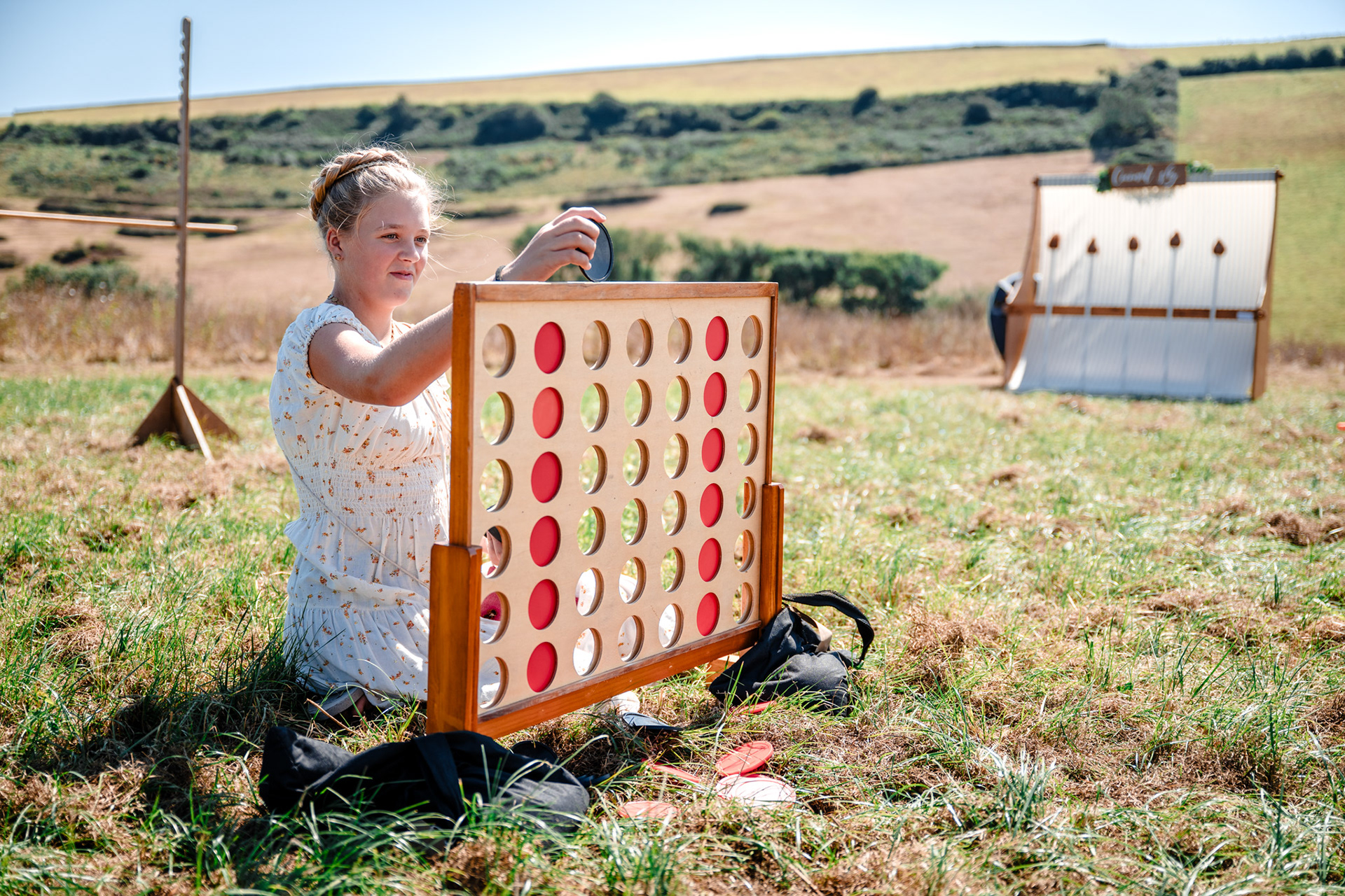 A young girl plays connect for at a Devon countryside wedding.