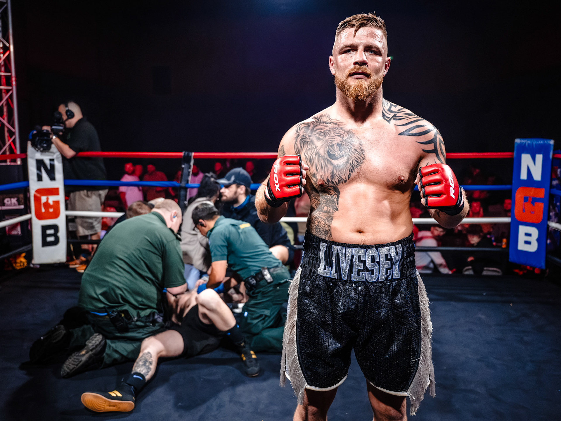 James Livesey poses infant of his downed opponent in a Torquay hybrid boxing event.