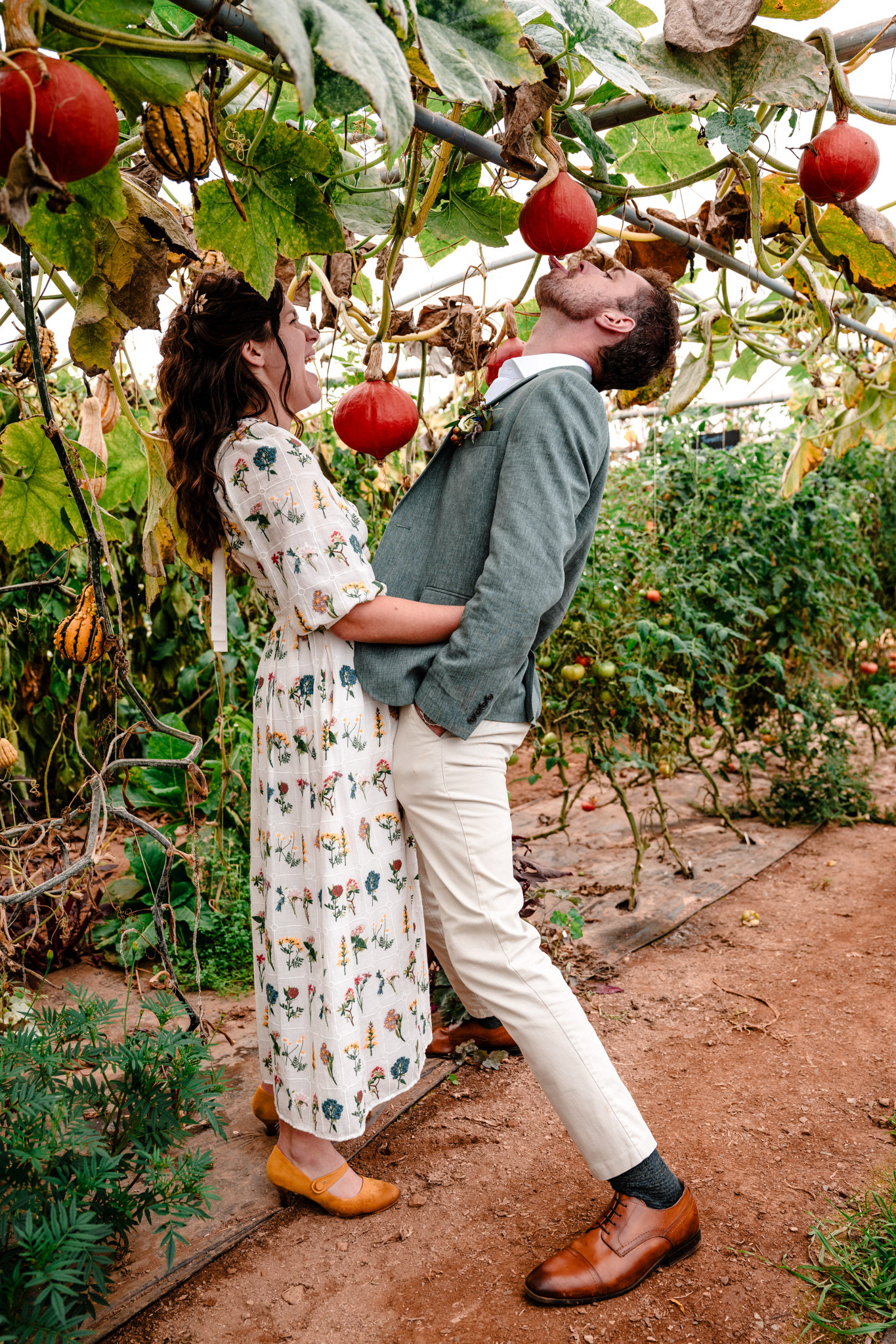 Newlyweds pose comically during couples portraits at their wedding.