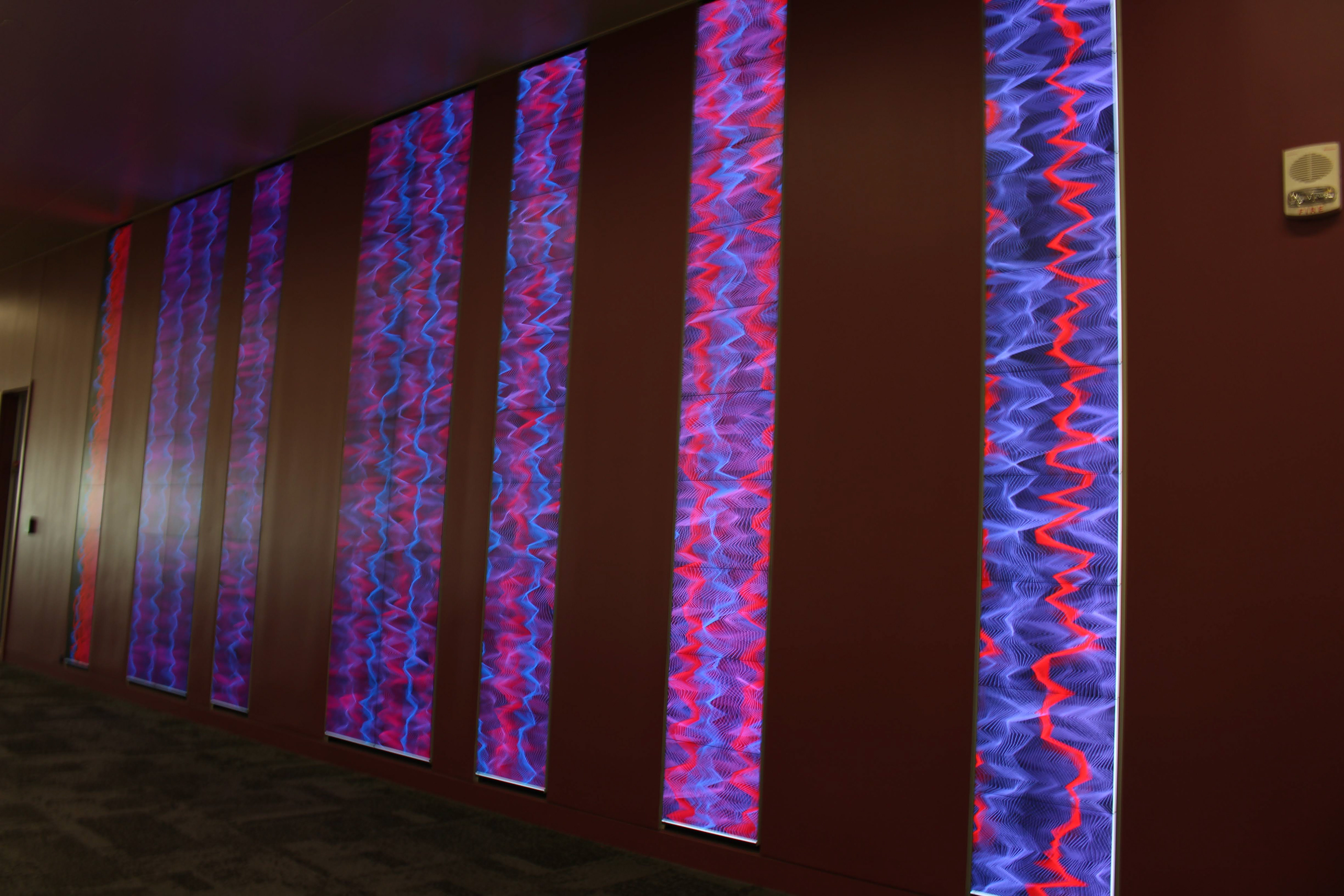 Code art on display wall outside the Teaching & Visualization Lab at Hunt