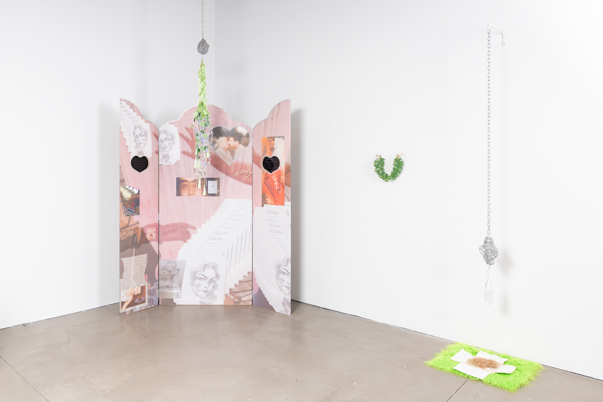 “The World: A World Full of Lies(Dunya Yalan Dunyasi)”, 2024, Installation, Material: CNC MDF, 2 Monitors with looped moving images, Fabricated glass beads, Aluminum Casted Tiles, Chains, Tassels, Pre-fabricated plastic leaves, metal rosary, Bracket, Props grapes.