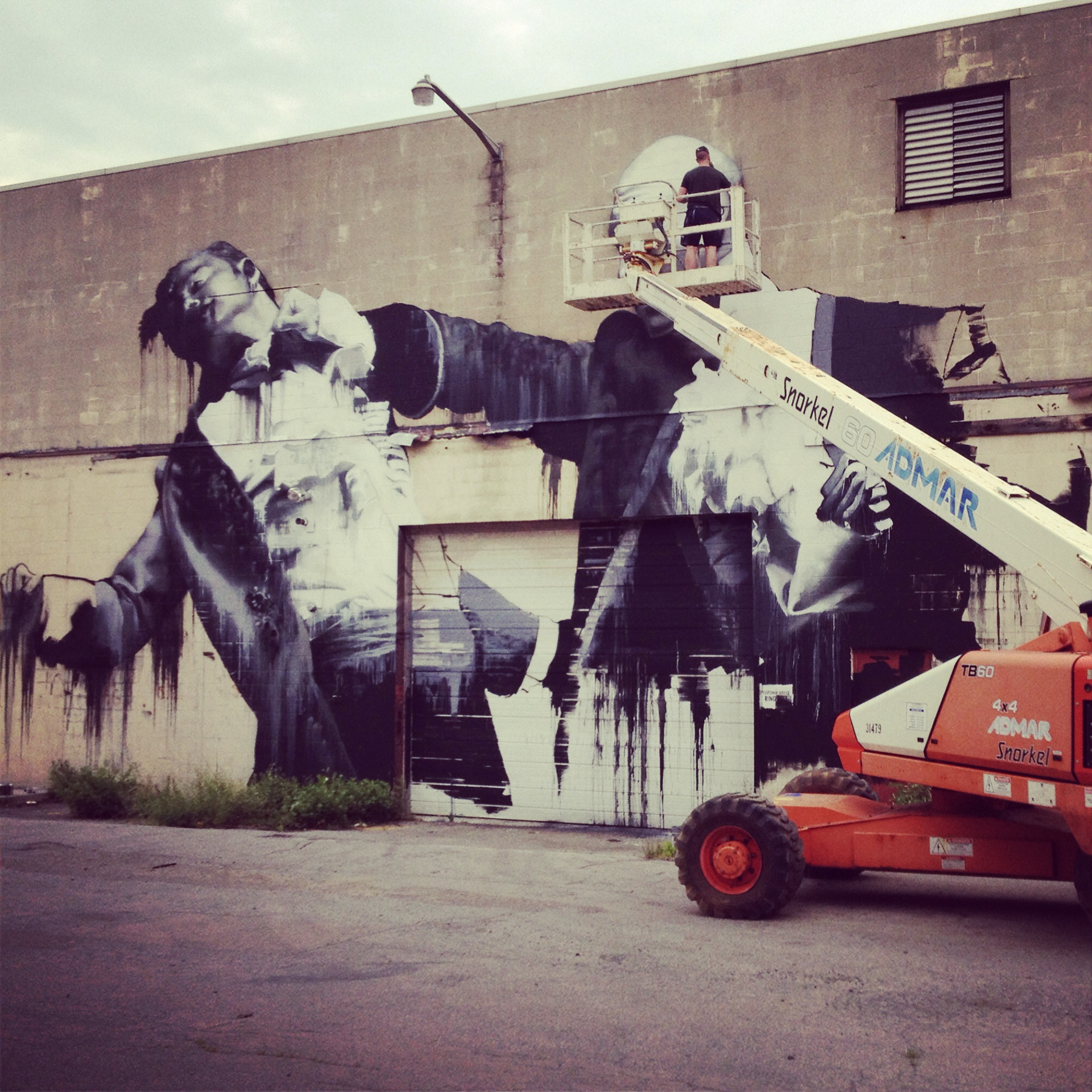 Painting a mural with Connor Harrington of London.