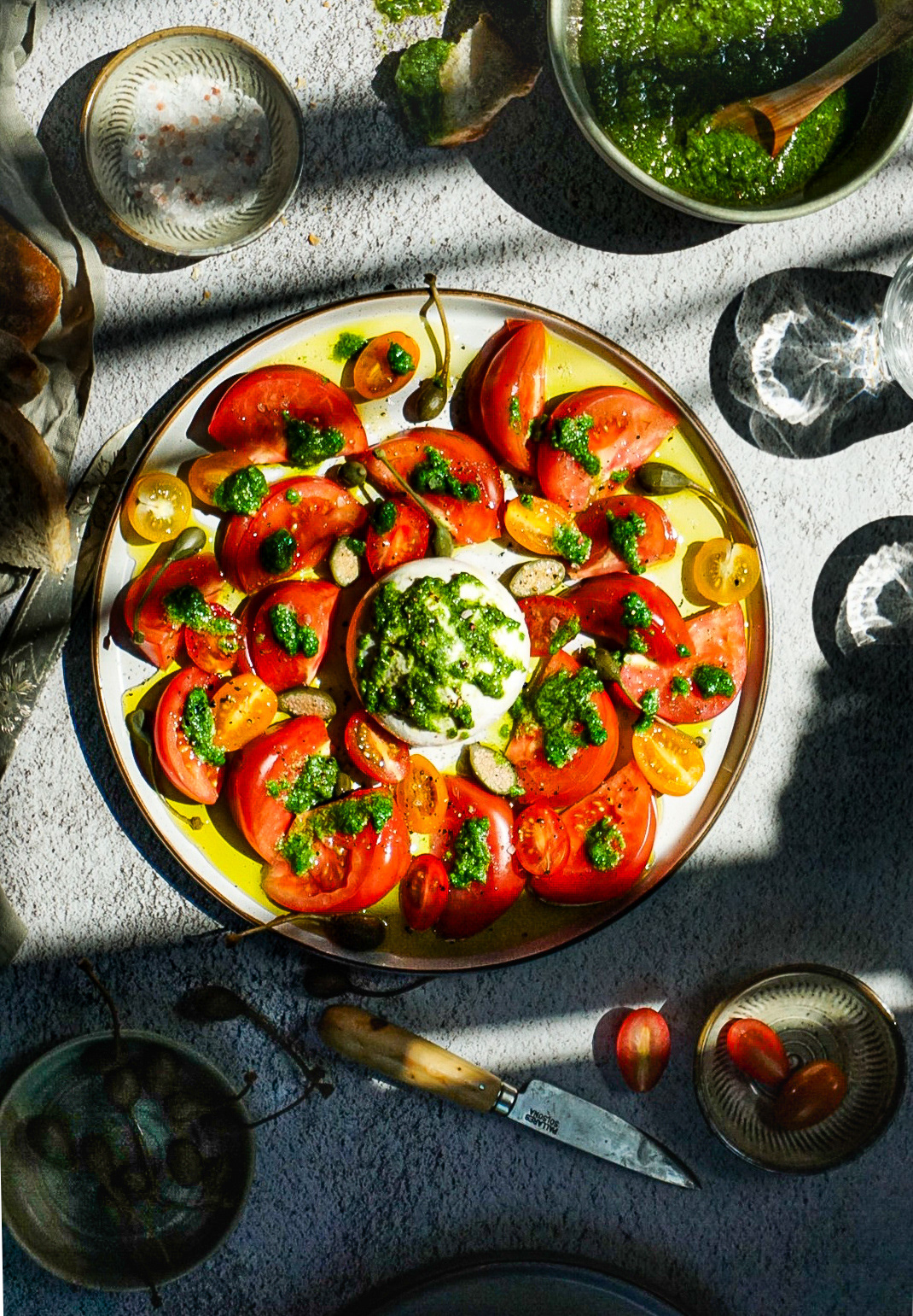 Tomato and burrata salad with wild garlic pesto.  Harsh light and shadows Project.
