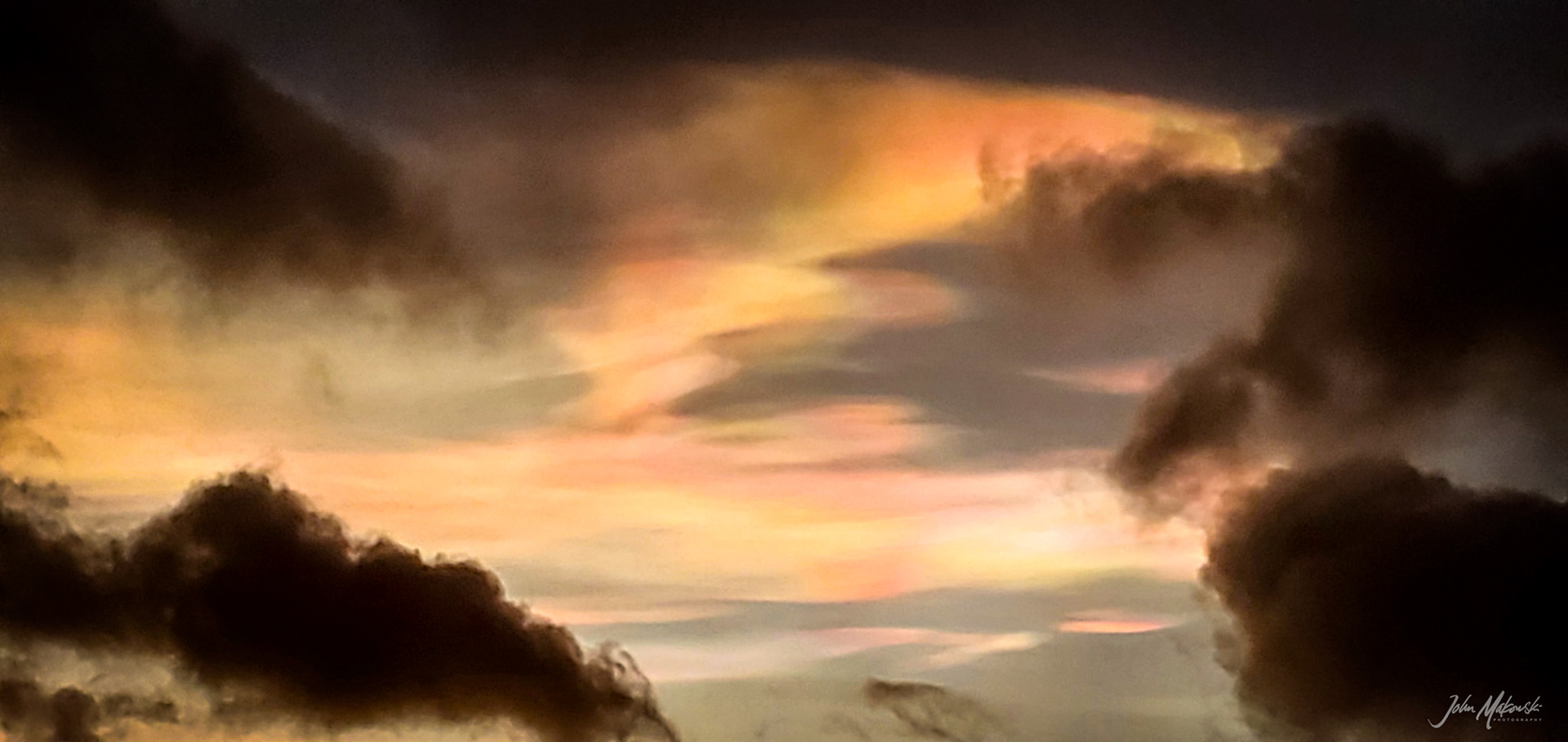Nacreous clouds (Mother-of-Pearl clouds) at sunrise, Fjallsárlón Glacier lagoon.  Nacreous clouds form in very cold conditions over polar  regions and within the stratosphere, around 12 to 19 miles high.