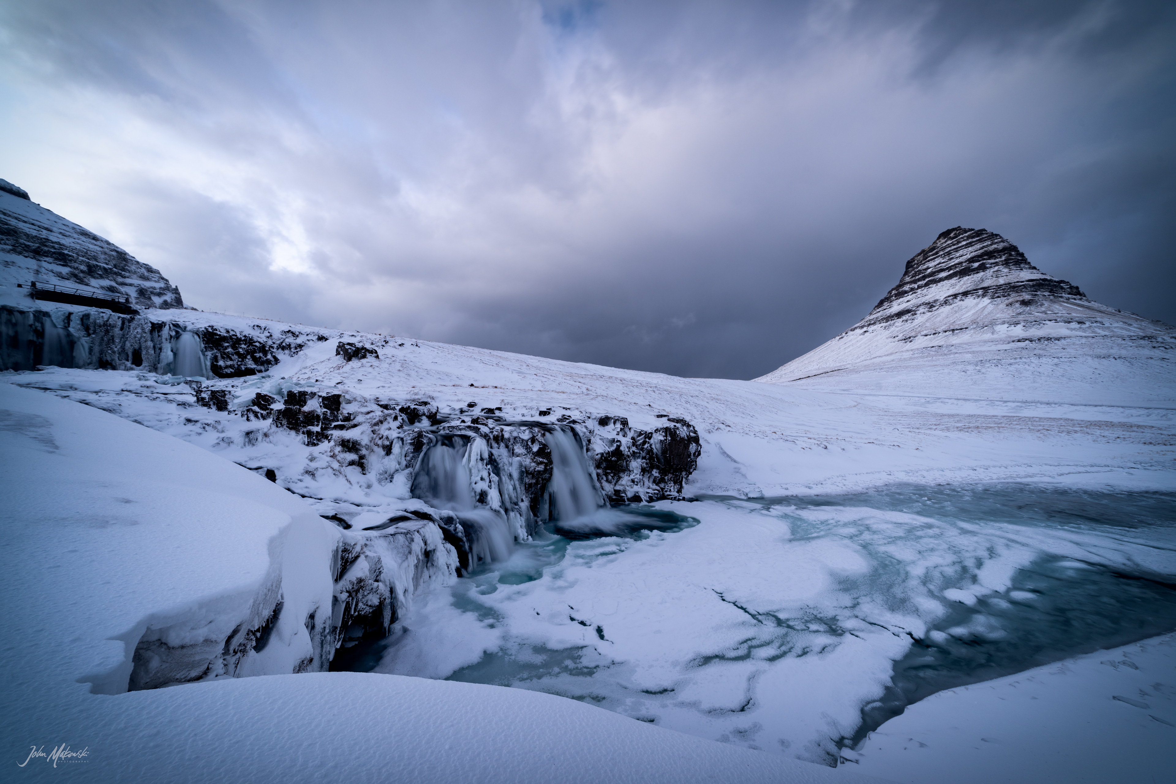Kirkjufellsfoss that channels the glacial water of Snaefellsjokull glacier and Kirkjufell on the Snaefellsnes Peninsula 