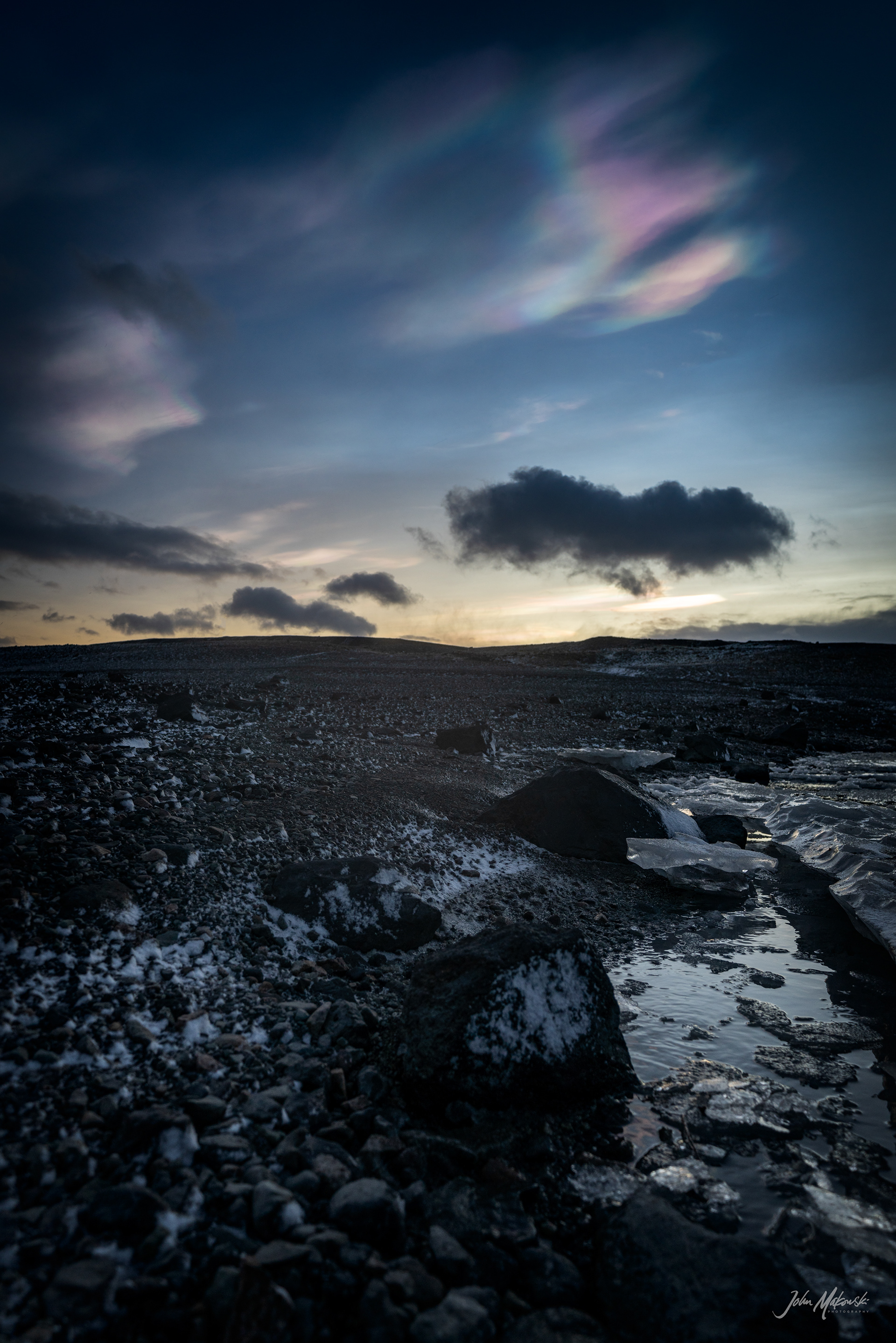 Nacreous clouds (Mother-of-Pearl clouds) at sunrise, Fjallsárlón Glacier lagoon.  Nacreous clouds form in very cold conditions over polar  regions and within the stratosphere, around 12 to 19 miles high.