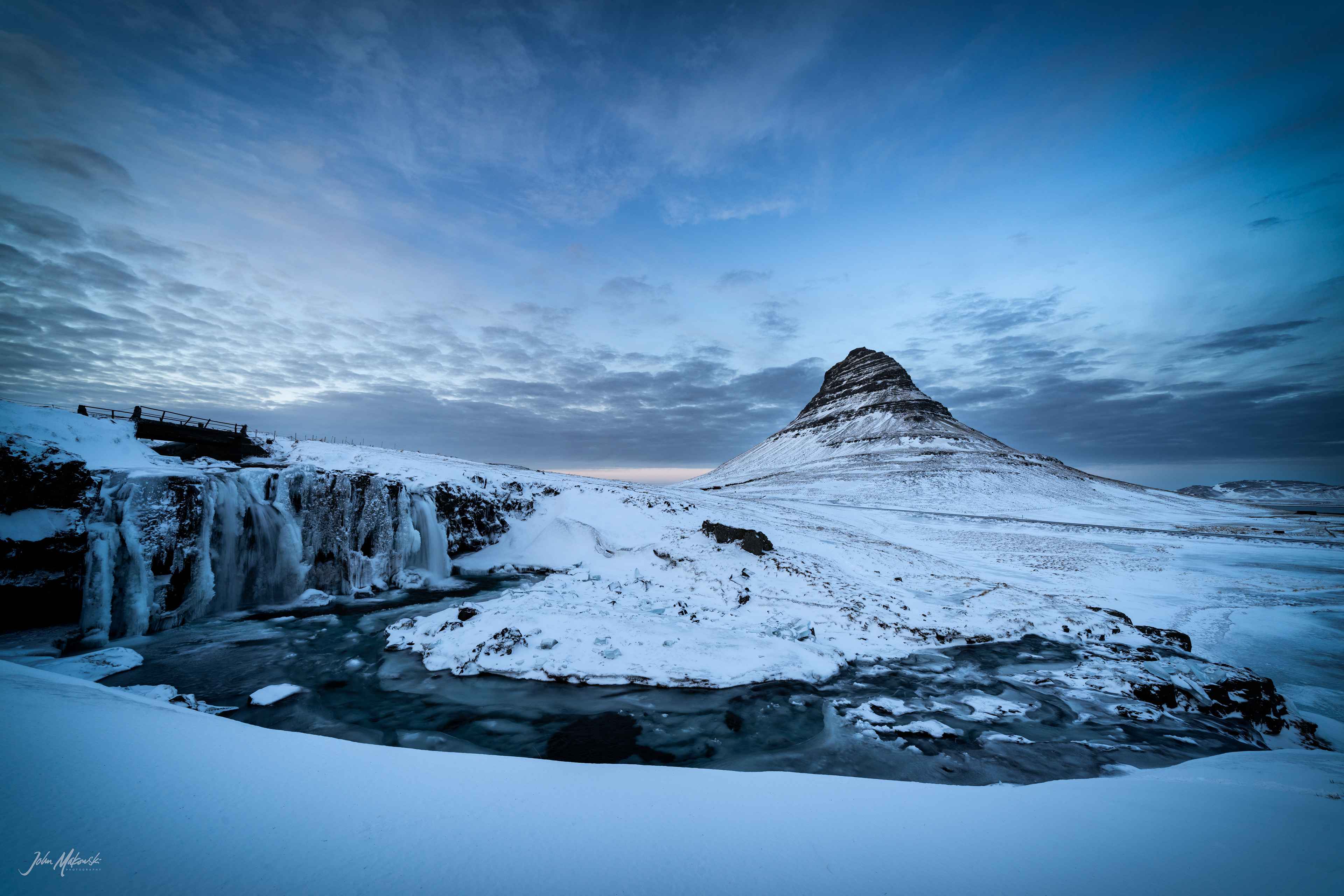 Kirkjufellsfoss that channels the glacial water of Snaefellsjokull glacier and Kirkjufell on the Snaefellsnes Peninsula 